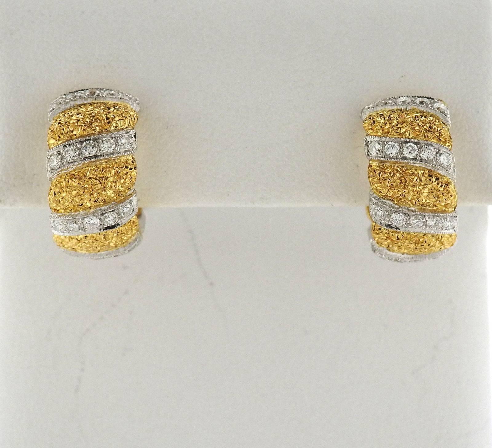 A pair of 18k white and yellow gold hoop earrings, crafted by Buccellati, featuring approximately 0.86ctw in diamonds. Earrings are 17mm in diameter x 9mm wide . Marked: Buccellati, 18k Italy . Weight: 11.8 grams 