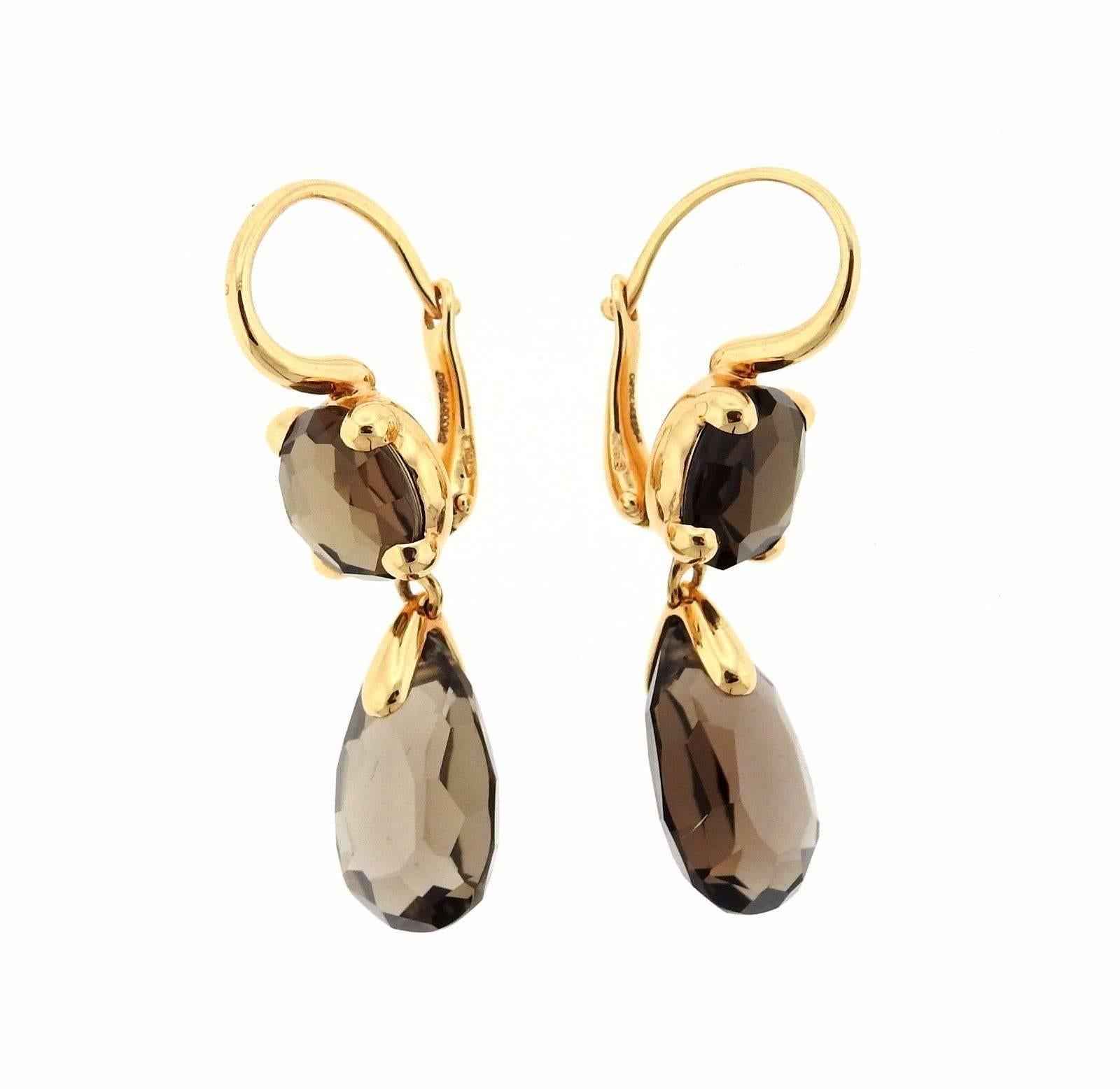A pair of 18k yellow gold earrings set with smokey quartz.  The earrings are 35mm x 9mm and weigh 8.6 grams.  Marked: Pomellato, 750.