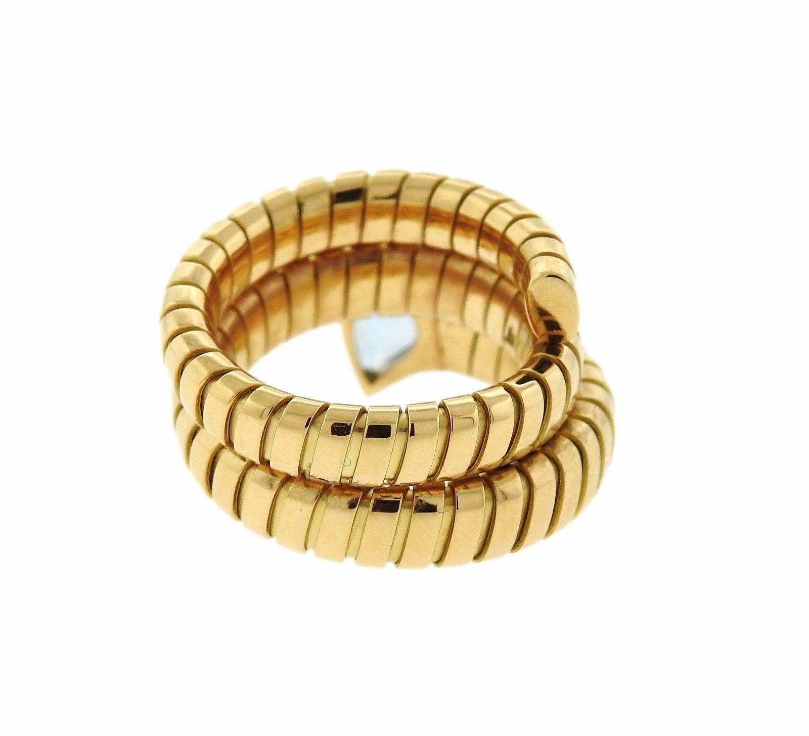 18k gold wrap ring, crafted by Bulgari for Tubogas collection, set with aquamarine gemstone. Ring size - 7 (slightly flexible)  ring top is 17mm wide. Marked: 10 MI, 750, Bvlgari . Weight: 14.4 grams
Retail $6750