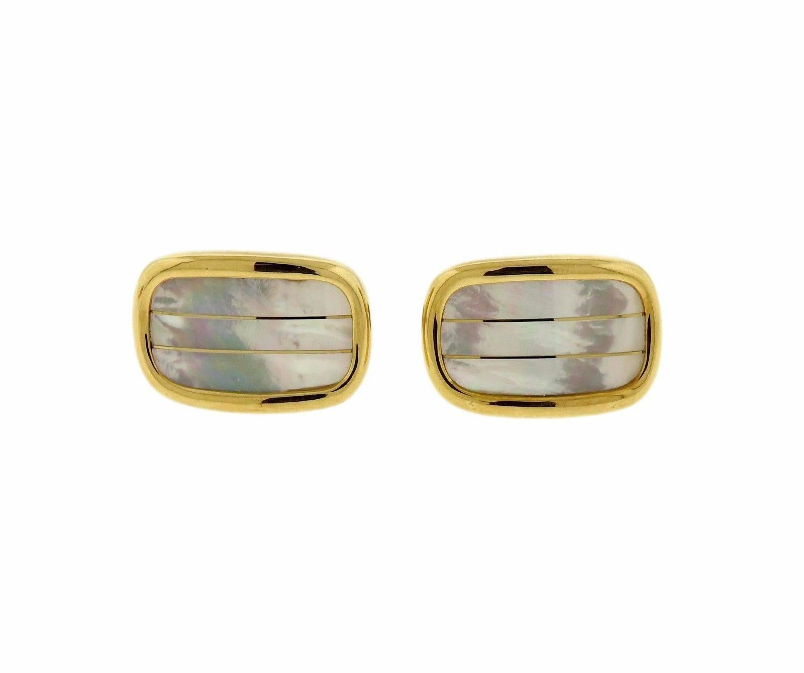 An 18k gold cufflinks and stud set, set with mother of pearl . Cufflink top measures 22mm x 15mm, stud top - 12mm x 8m. Weight of the set - 23.2 grams 
