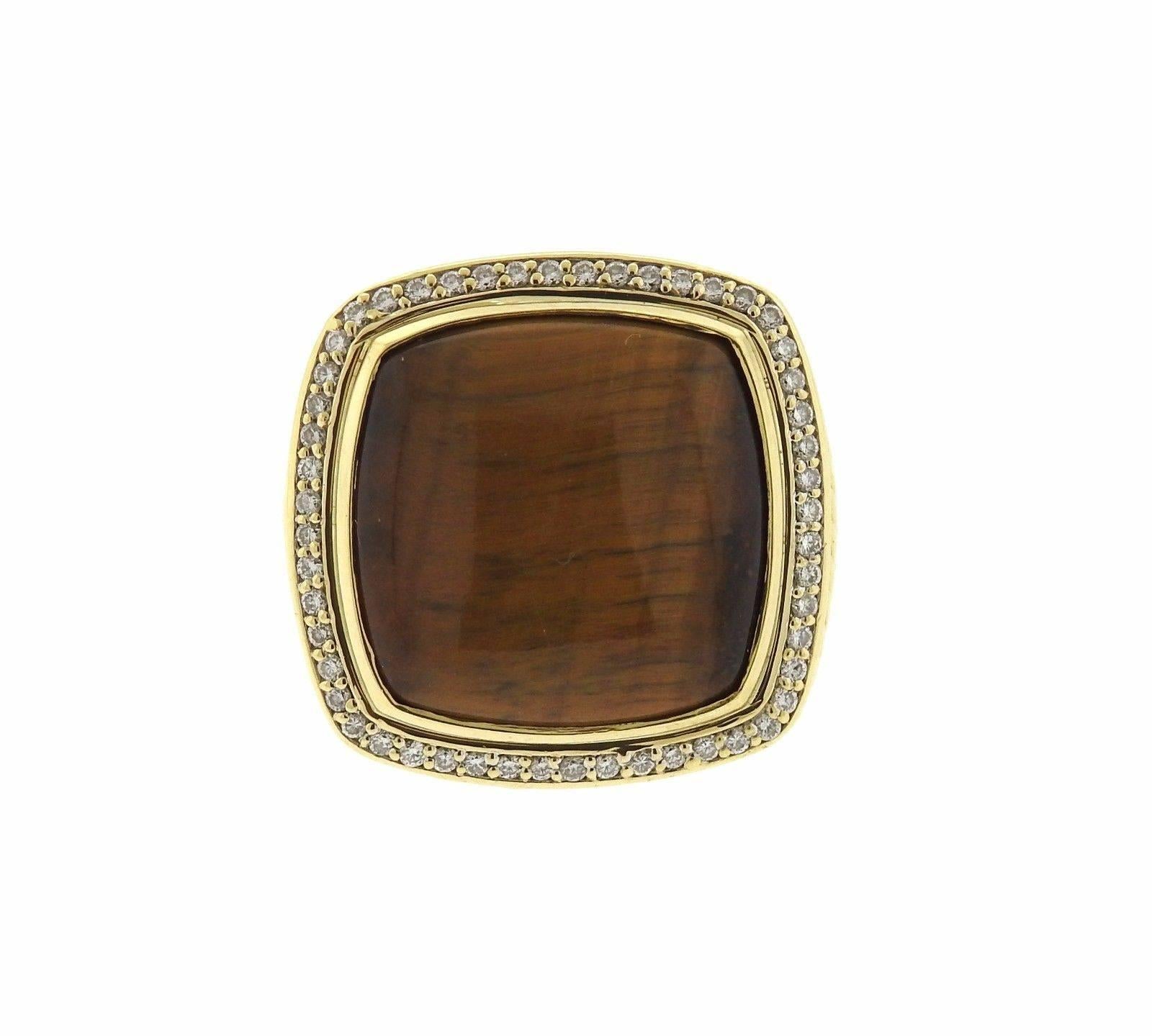 An 18k yellow gold ring set with tiger's eye and approximately 0.50ctw of H/VS diamonds.  The ring is a size 7 and the top of the ring measures 27mm x 27mm.  Marked: DY, 750.  The weight of the ring is 30.3 grams.