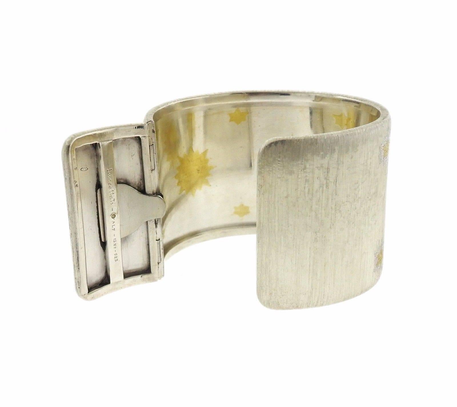 An 18k gold and sterling silver wide cuff bracelet by Buccellati.  The bracelet measures 44mm wide and will fit up to a 6.75