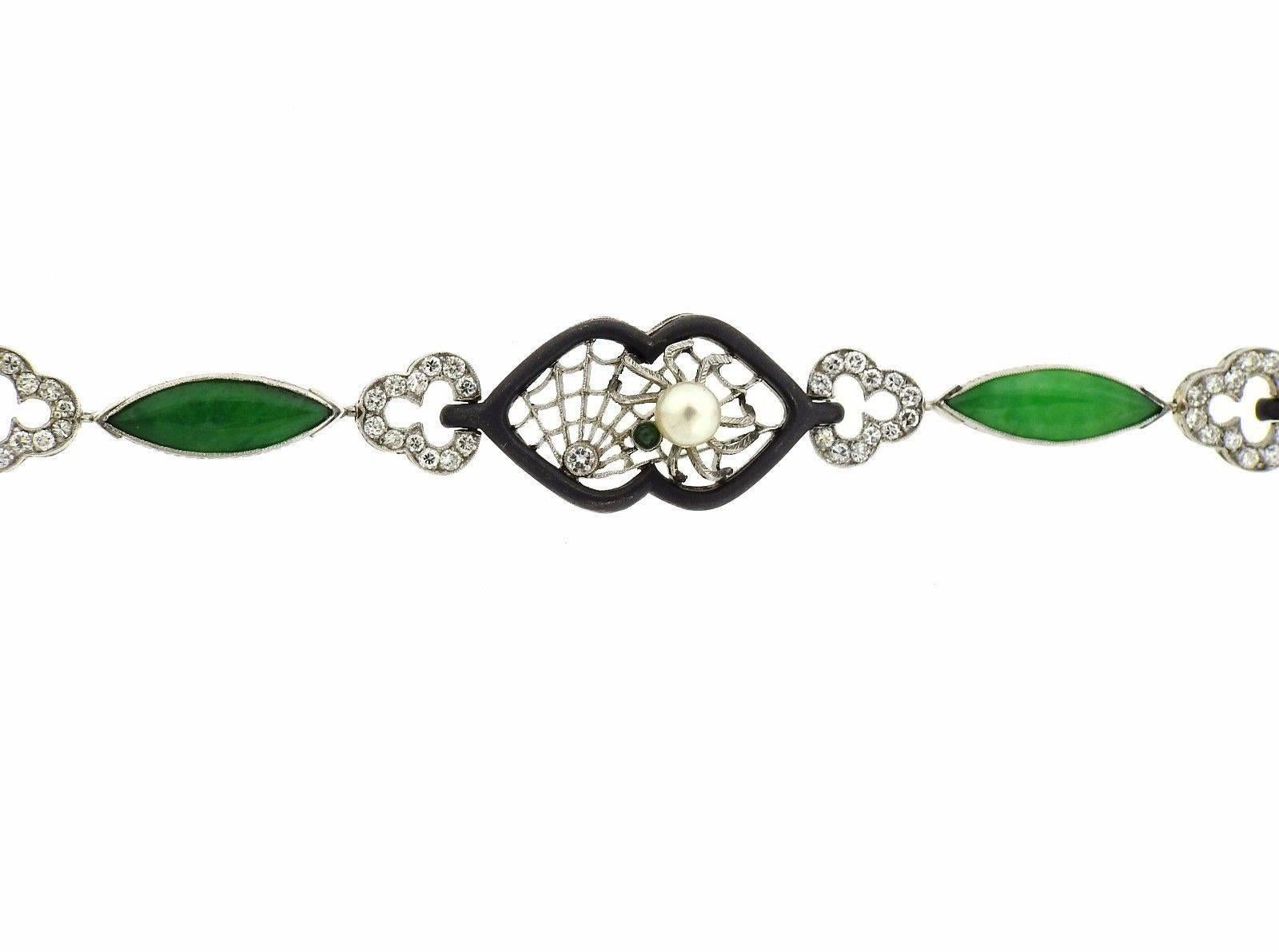 A 14K gold and oxidized steel beacelet set with jadeite, a 5.2mm pearl and approximately 1.40ctw of H/VS diamonds.  The bracelet is 7 3/4