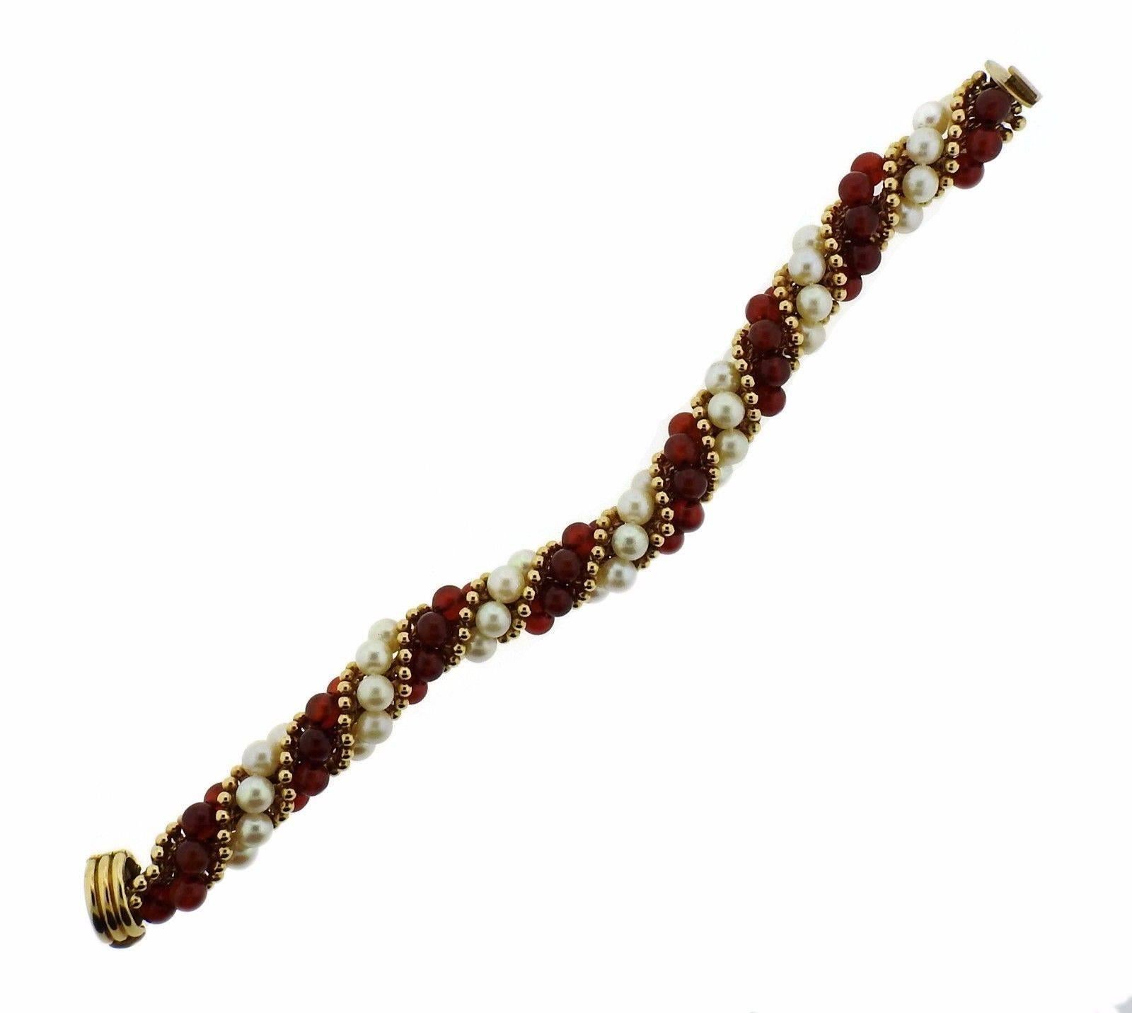 An 18k gold bracelet set with pearls (6.1mm - 6.5mm) and carnelian (6mm).  The bracelet is 8.5