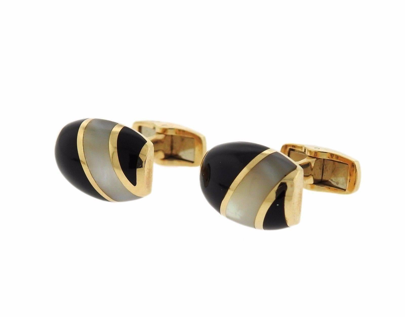 A 14k gold cufflinks and stud set adorned with mother of pearl and onyx. Cufflink tops 17.5mm x 12.5mm and the stud tops measure 14.5mm X 10mm.  The weight of the set is 30.5 grams.  Marked: 585, maker's mark, serial numbers.