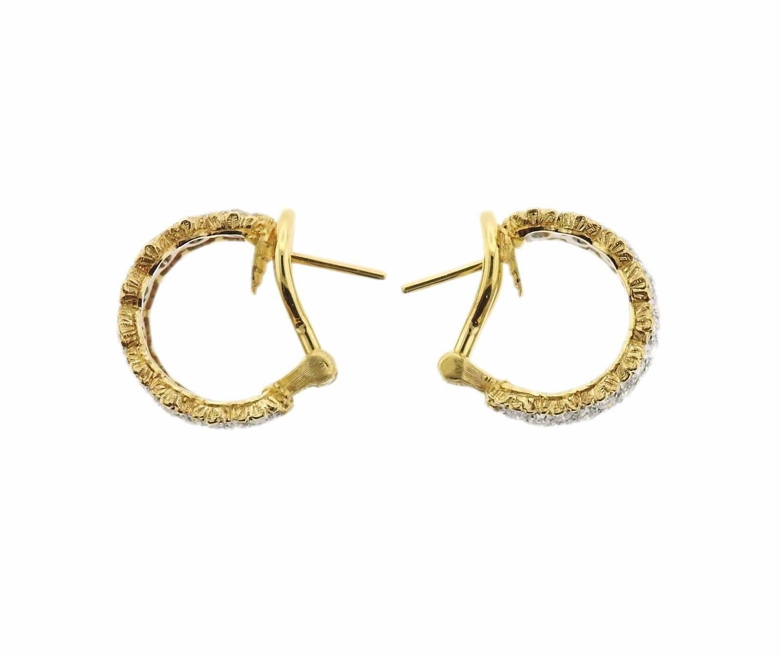 A pair of 18k yellow and white gold hoop earrings set with approximately 1.44ctw of GH/VS diamonds.  The earrings measure 14mm in diameter and 9mm in width.  The weight of the set is 8.3 grams.  Marked:	18k,  Italy, Buccellati.  The current retail