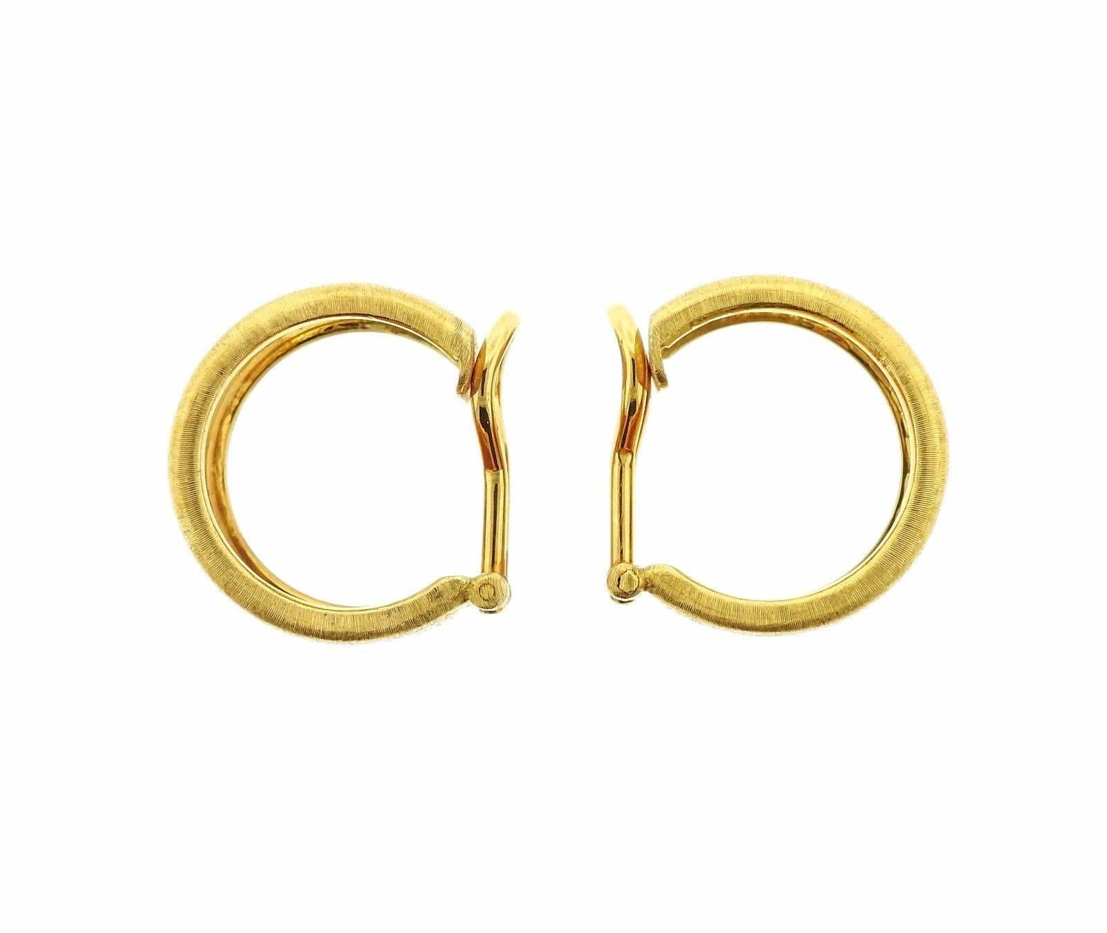 A pair of 18k yellow gold earrings adorned with enamel.  The earrings measure 19mm in diameter and 15mm in width.  The weight of the pair is 27.6 grams.  Marked: 18k,  Italy, Buccellati.  The retail is $19,630.