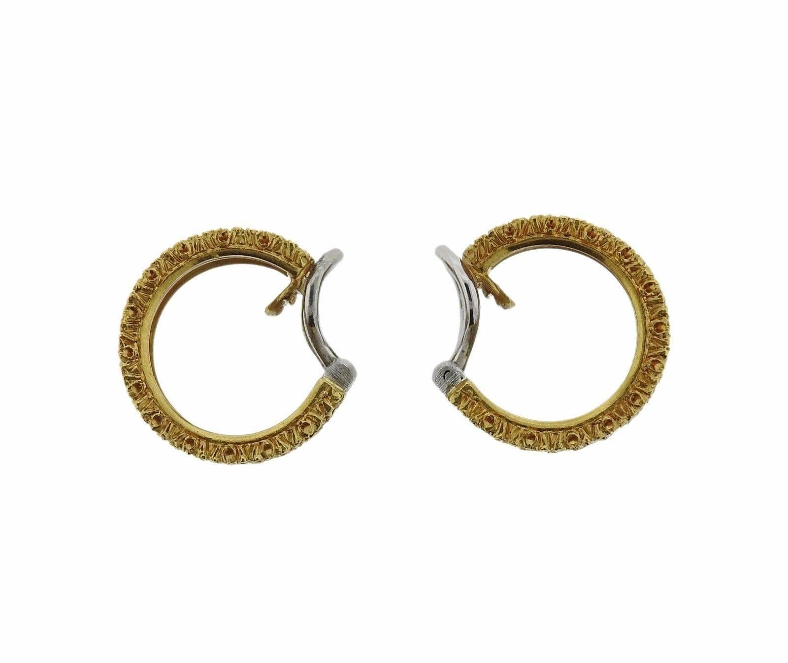 A pair of 18k yellow white gold hoop earrings set with approximately 1.96ctw of H/VS diamonds.  The earrings measure 14mm in diameter and 10mm in width.  The weight of the set is 14.2 grams. Marked:	18k,  Italy, Buccellati.  Retail is $25,230.