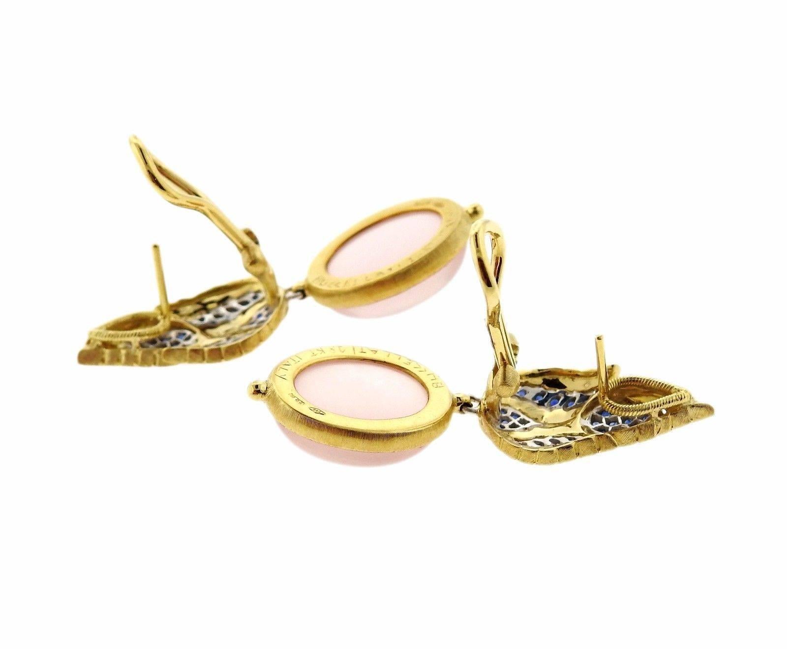 A pair of 18k yellow and white gold earrings set with sapphires and rose quartz cabochons.  The earrings measure 41mm x 14mm and weigh 16.2 grams.  Marked: 18k, Italy, Buccellati.