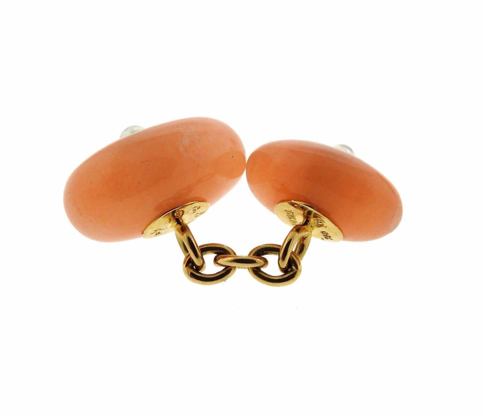 A pair of 18k gold cufflinks set with pinkish peach gemstones and 2.5mm pearls. The cufflink tops are 16mm X 10mm and 14mm X 9mm.  The pair weighs 9.4 grams.  Marked: Trianon,750.