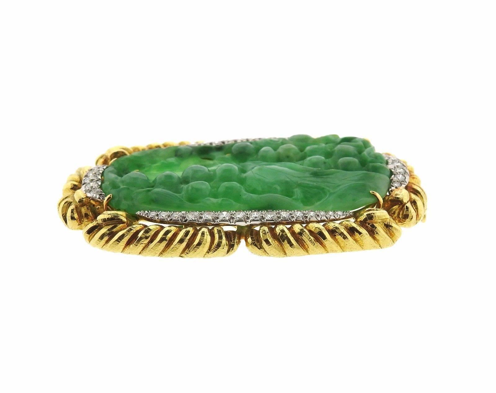 An 18k gold and platinum brooch set with carved jade and approximately 1.70ctw of G/VS diamonds.  The brooch measures 67mm x 42mm and 42.7 grams.  Marked: David Webb, 18k, Plat