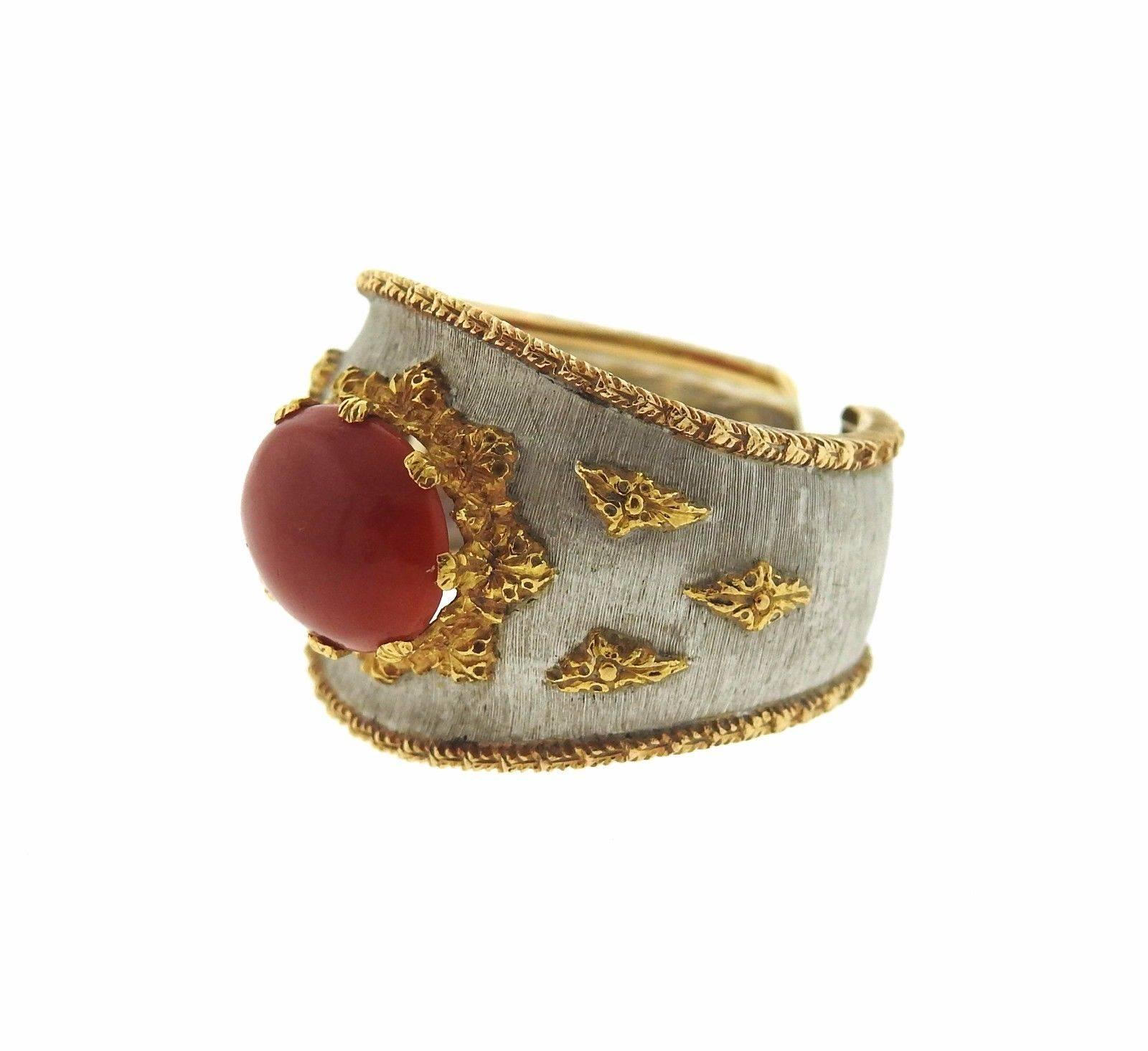 An 18k gold cuff ring set with a coral (10mm x 8mm).  The ring is a size 4.75 and 15.7mm wide.  The weight of the piece is 8.7 grams.  Marked: Buccellati, Italy, 750.