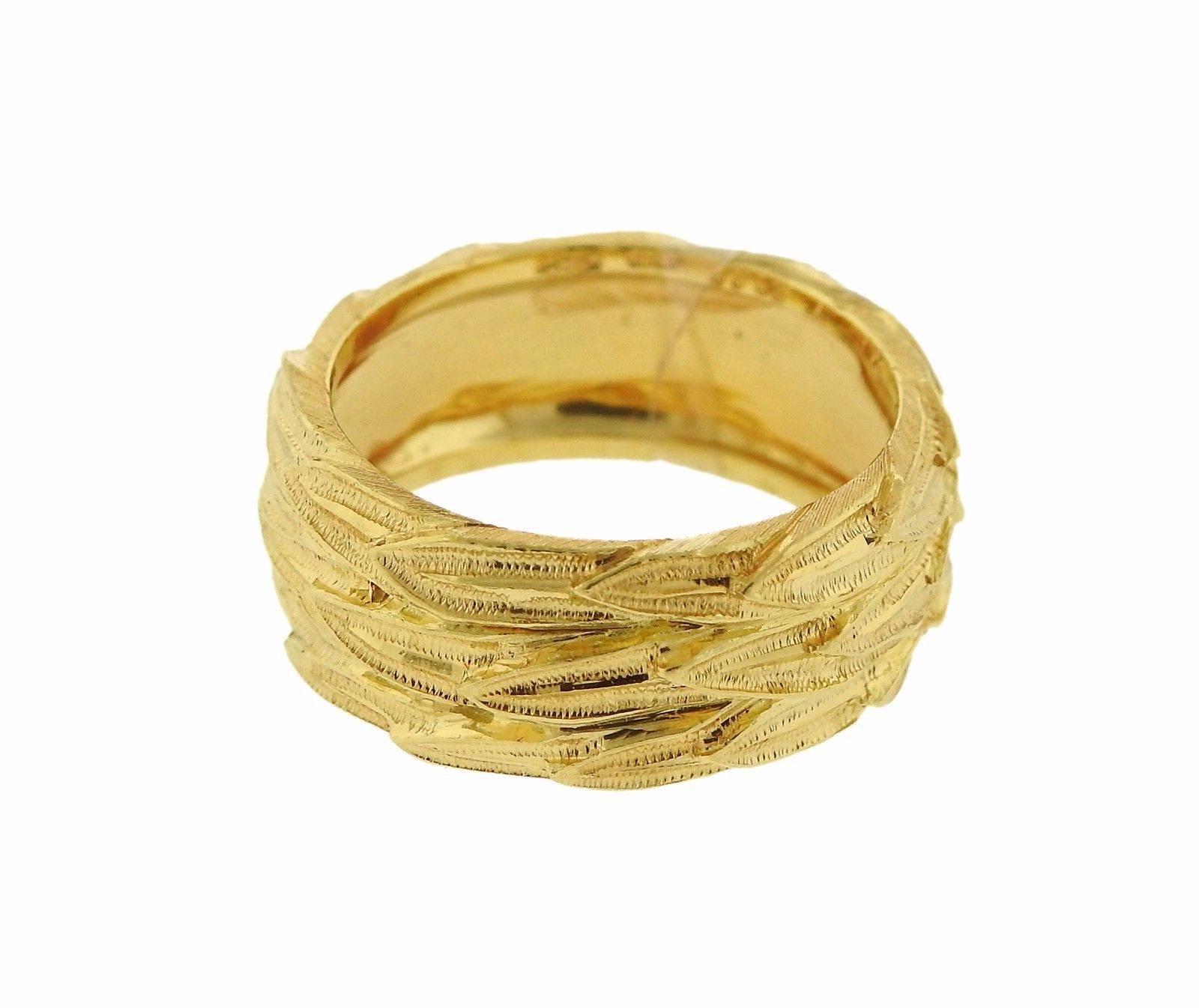 An 18K gold band ring by Buccellati.  The ring is a size 6.75 and is 8.3mm wide. The weight of the piece is 7.9 grams. Marked: 18K, Italy, Buccellati.  The retail is $4910.  Comes with Buccellati box and paperwork.