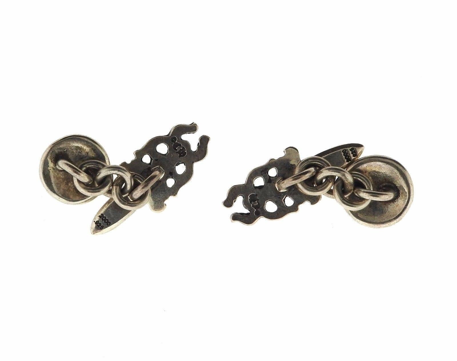 A pair of sterling silver cufflinks in the shape of daggers.  The cufflink tops measure 27mm x 11mm.  The weight of the piece is 14.4 grams.  Marked:	Chrome Hearts 2000 .925.