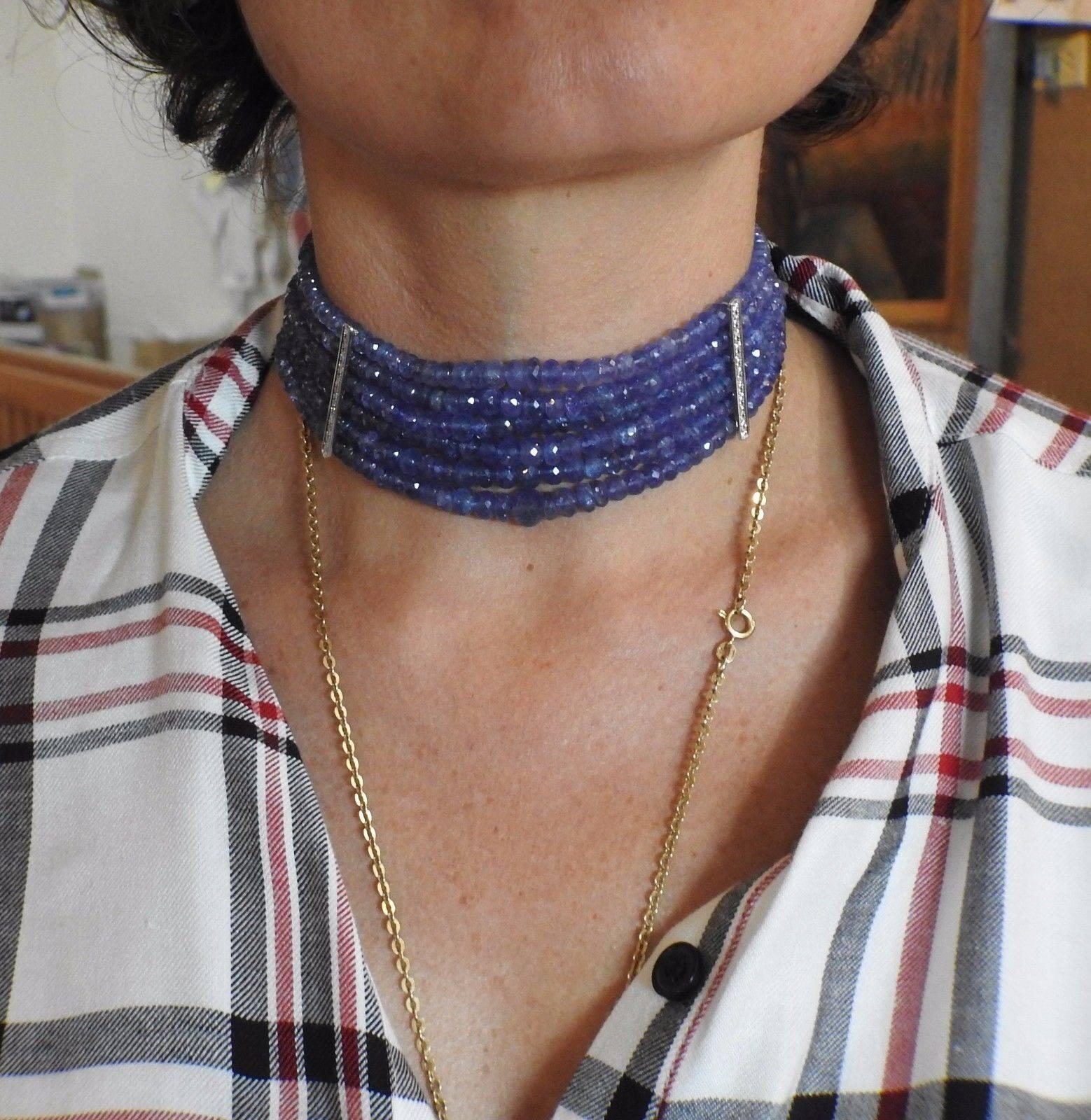 An 18k gold choker necklace set with tanzanite beads and approximately 0.22ctw of G/VS diamonds.  The necklace is 12.5