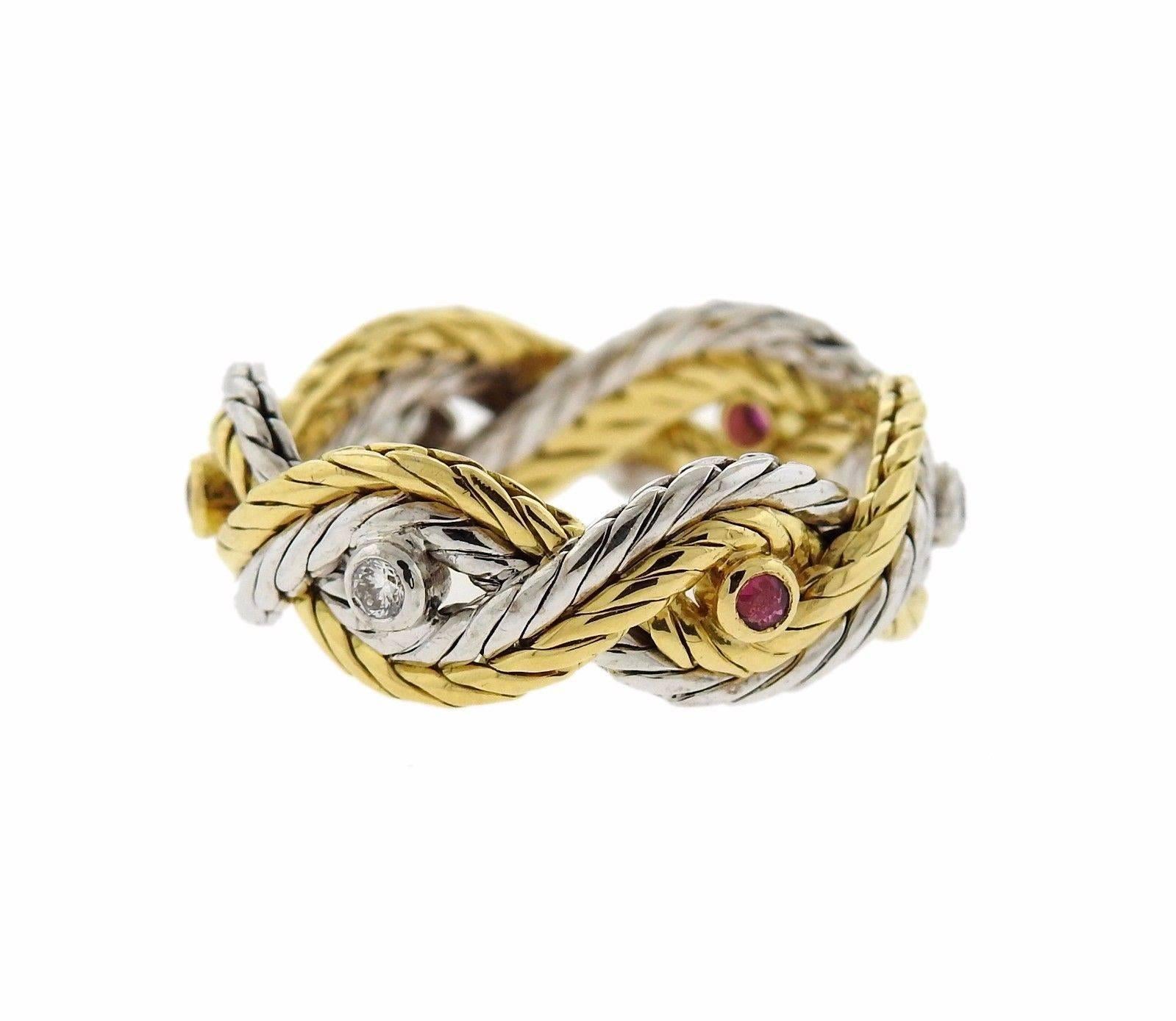 An 18k gold band ring set with rubies and approximately 0.06ctw of G/VS diamonds.  The ring is a size 8.5 and is 8mm wide. The weight of the piece is 8 grams. Marked: Buccellati, 750, Italy, 18kt.