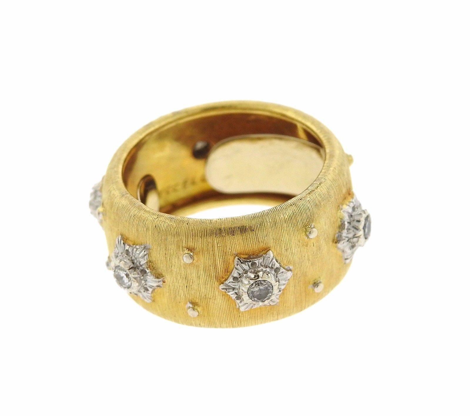 An 18k yellow and white gold band ring set with 0.18ctw of VS-SI/H-I diamonds.  The ring is a size 6.5 and is 11mm wide.  The weight of the piece is 10.9 grams.  Marked: Buccellati 18k.
