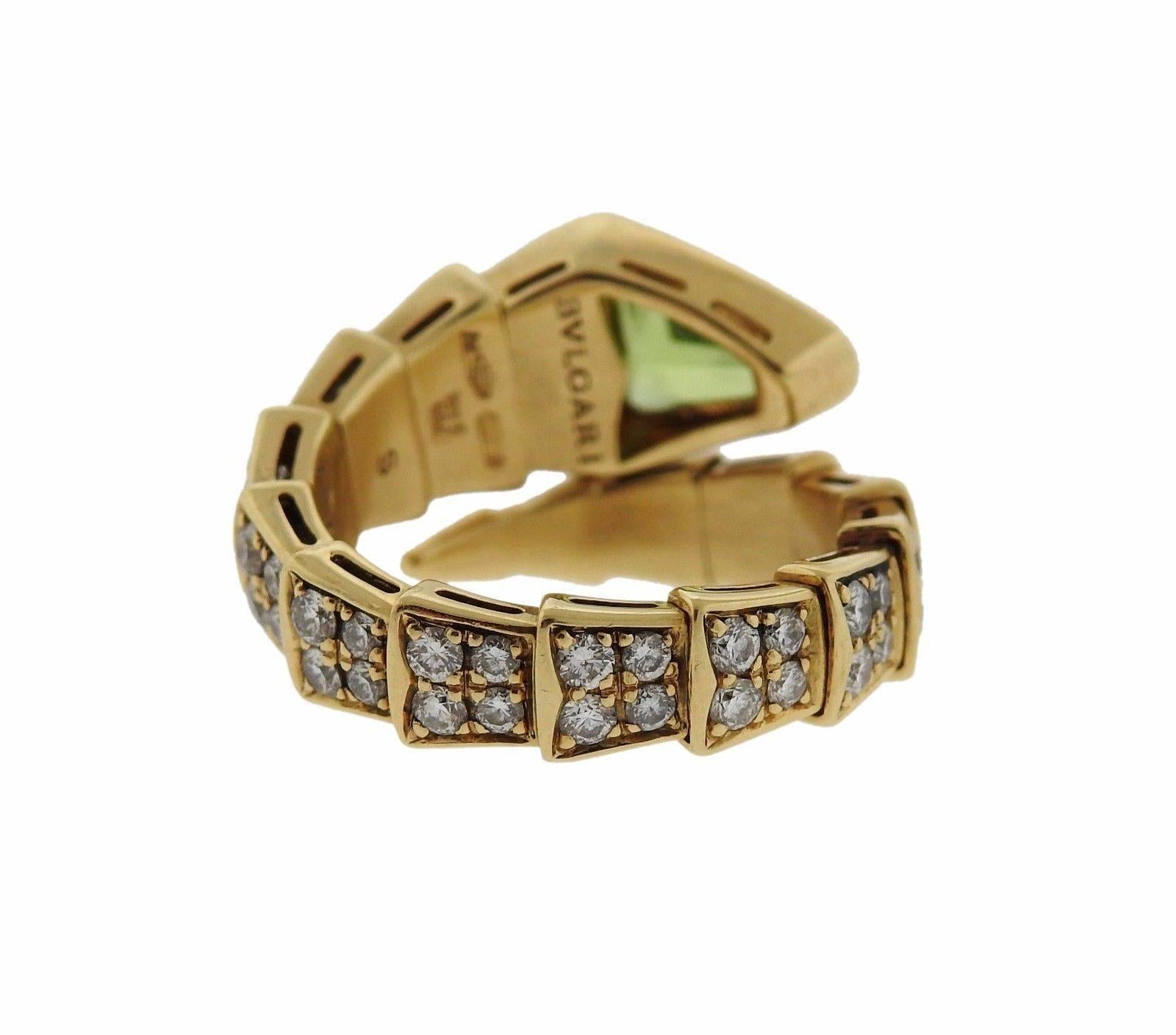 An 18k yellow gold ring set with peridot and approx. 0.90ctw of G/VS diamonds.  The ring is slightly flexible, will fit a size 6.5-7.5 and is 10mm wide.  The weight of the piece is 8.8 grams.  Marked: Bvlgari, 750, Made in Italy, S.  The retail for