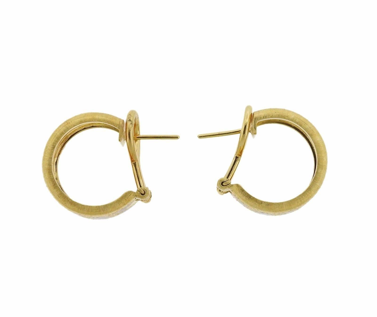 A pair of 18k gold hoop earrings adorned with blue enamel.  The earrings measure 16mm in diameter and weigh 14.8 grams.  Marked: Buccellati 18K Italy.  The retail for this pair is $12,900. Comes with Buccellati paperwork.
