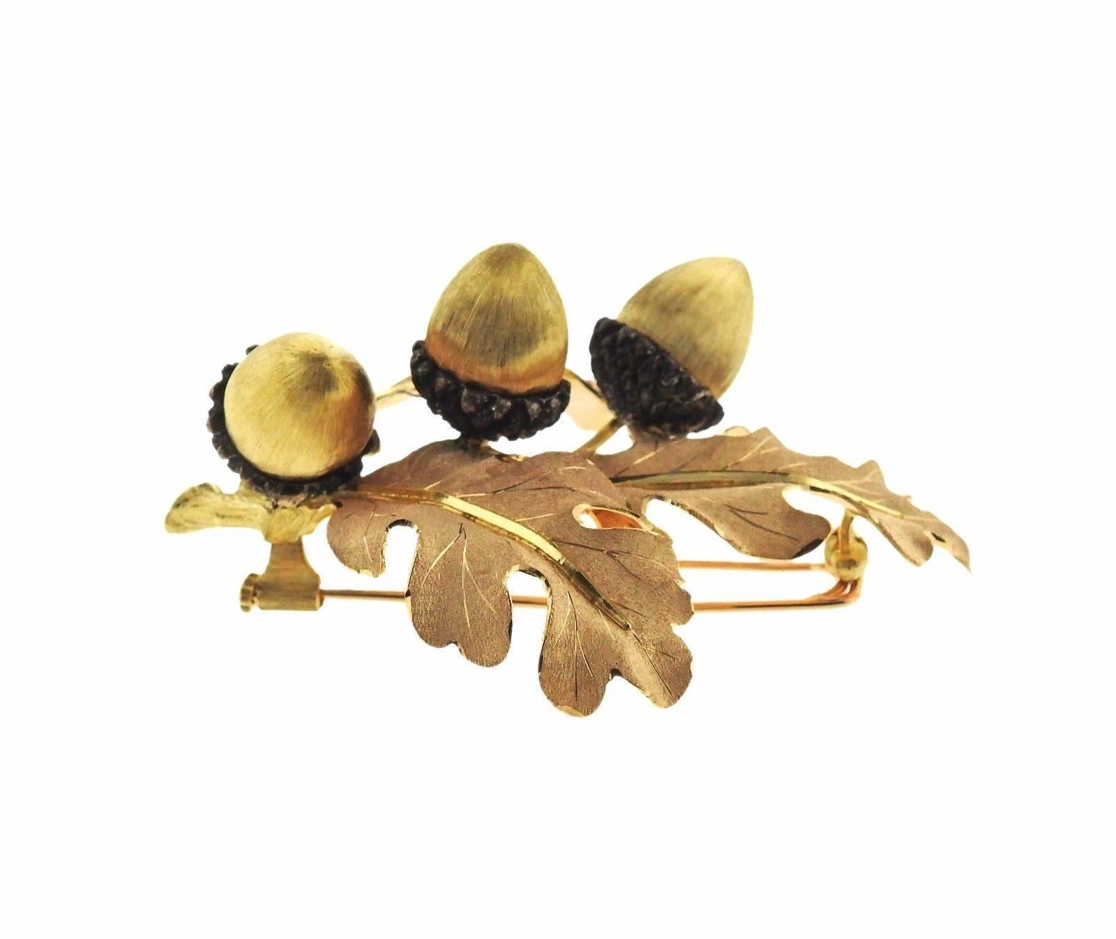 An 18k gold and sterling silver acorn brooch pin.  The brooch measures 58mm X 44mm and weighs 26.7 grams.  Marked: Buccellati 18K Italy.  Comes with Buccellati paperwork. Retail is $12620.