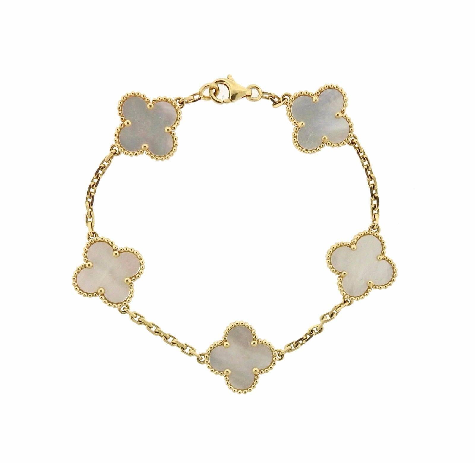 An 18k gold bracelet set with mother of pearl.  The bracelet is 7