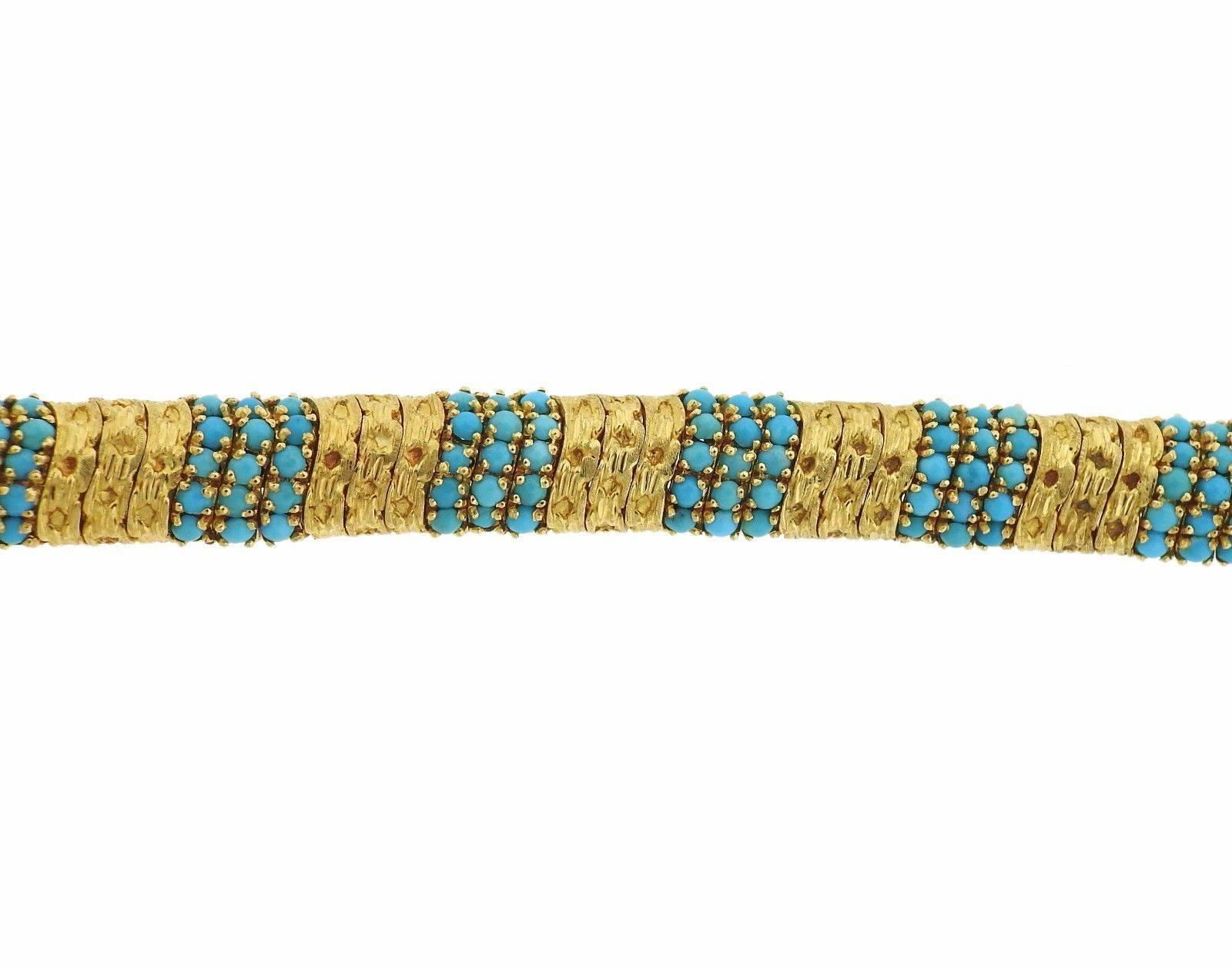 An 18k gold bracelet set with turquoise.  The bracelet is 7.5" long and 12mm wide.  The piece weighs 7.5" long and 12mm wide.  The weight of the piece is 77.8 grams.  Marked: 469MI, 750.