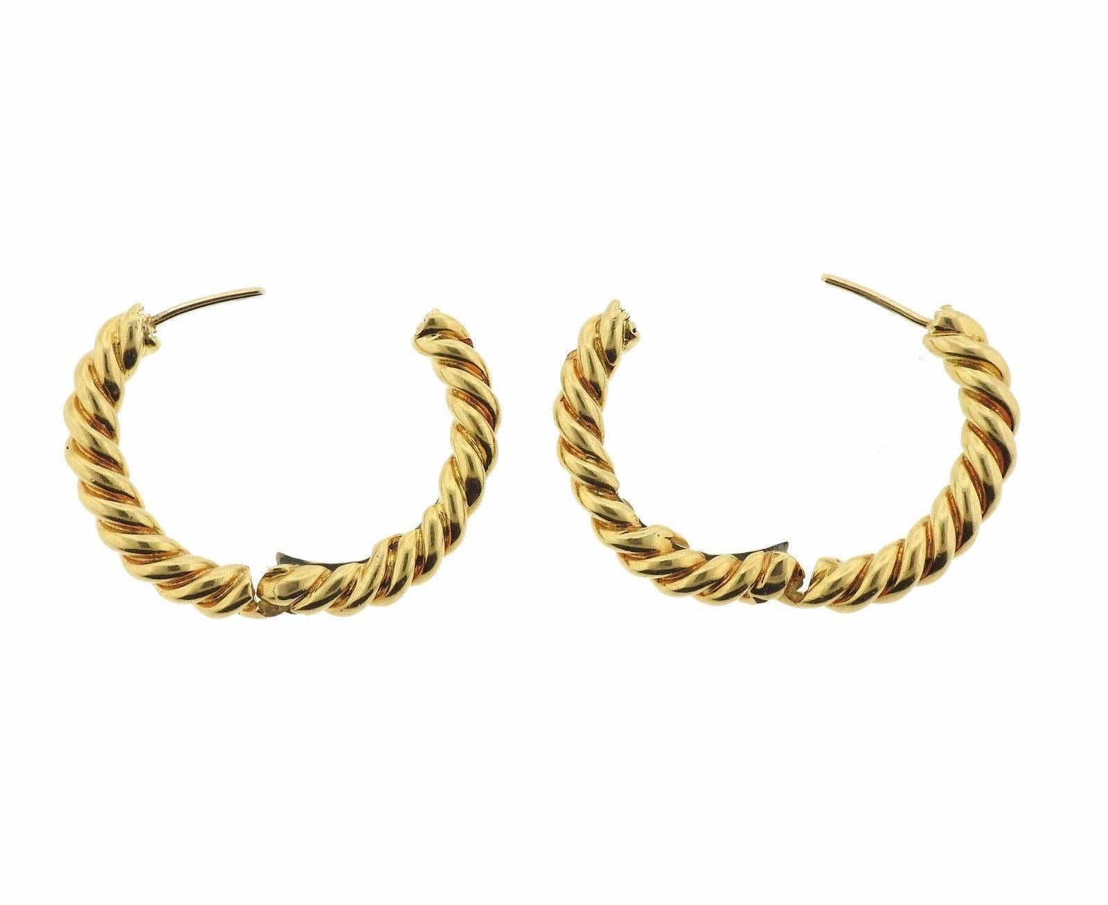 A pair of 18K gold hoop earrings.  The earrings measure 26mm long

MEASUREMENTS	Earrings measure 26mm long x 3.9mm wide.  The weight of the pair is 18,2 grams.  Marked: Webb, 18k.