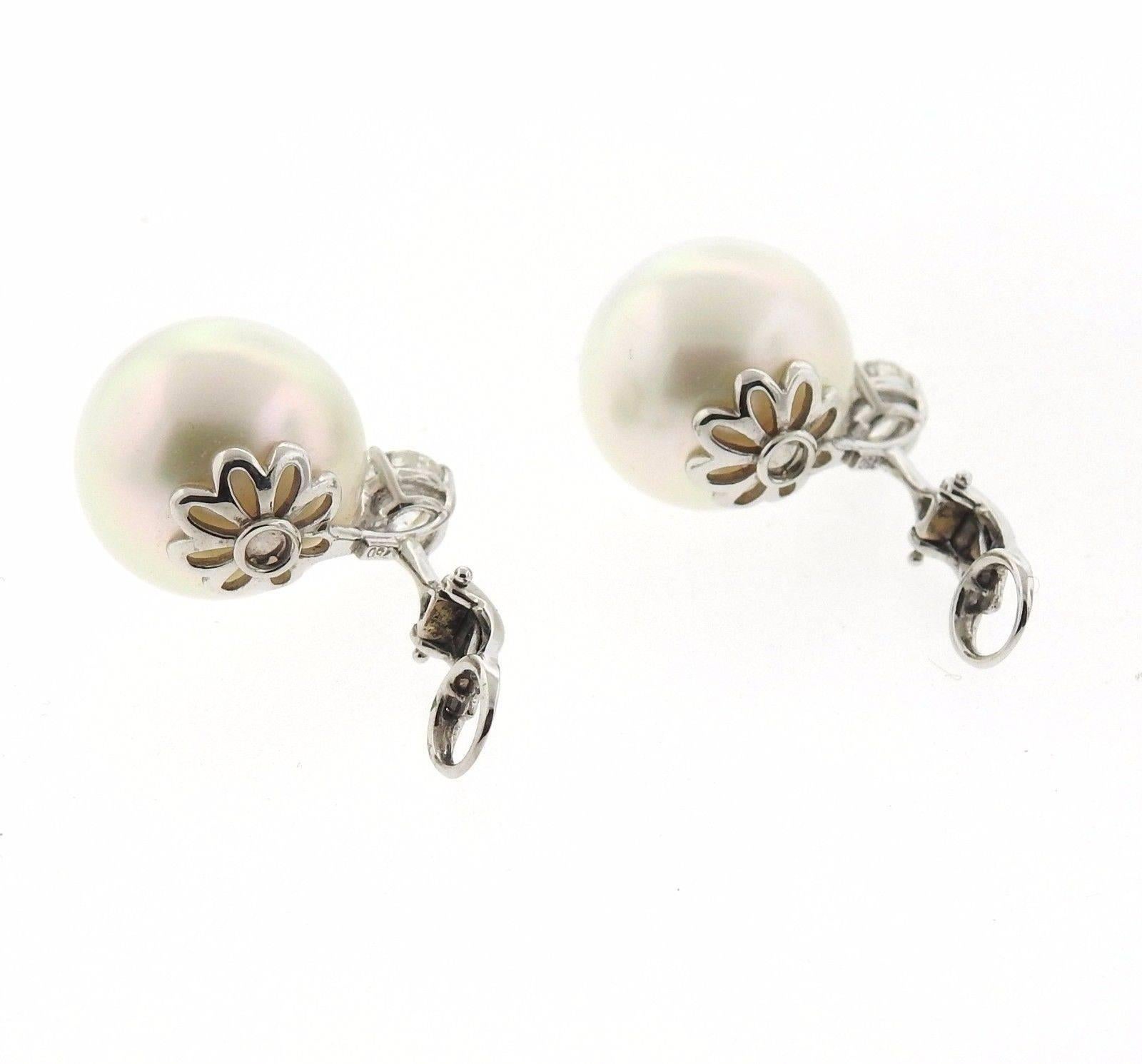 A pair of 18k gold earrings set with 15.5mm South Sea pearls and 1.60ctw of H-I/SI diamonds.  The earrings measure 21mm long and weigh 15.4 grams.
