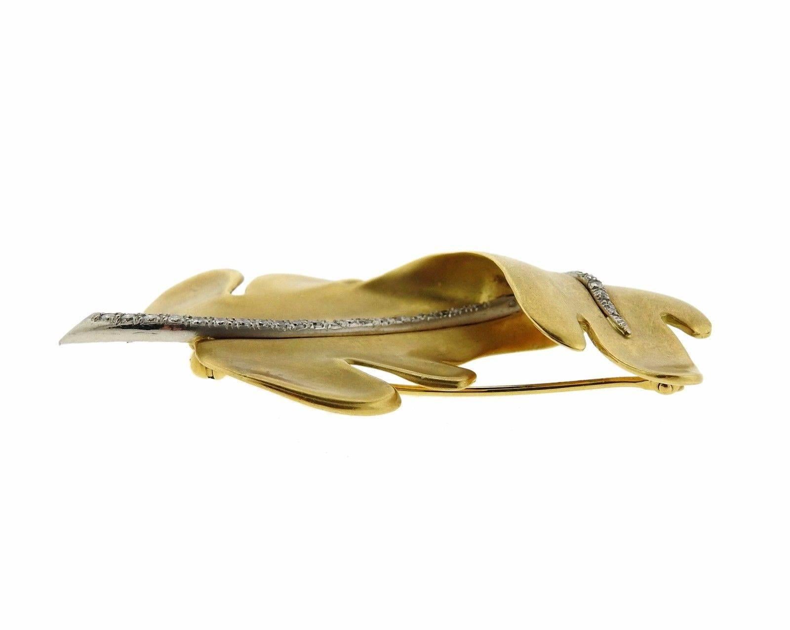 An 18k yellow gold leaf brooch set with approximately 0.20ctw of G/VS diamonds.  The brooch measures 55mm x 32mm and weighs 16.5 grams.  Marked: 1987, Tiffany & Co, 18k.