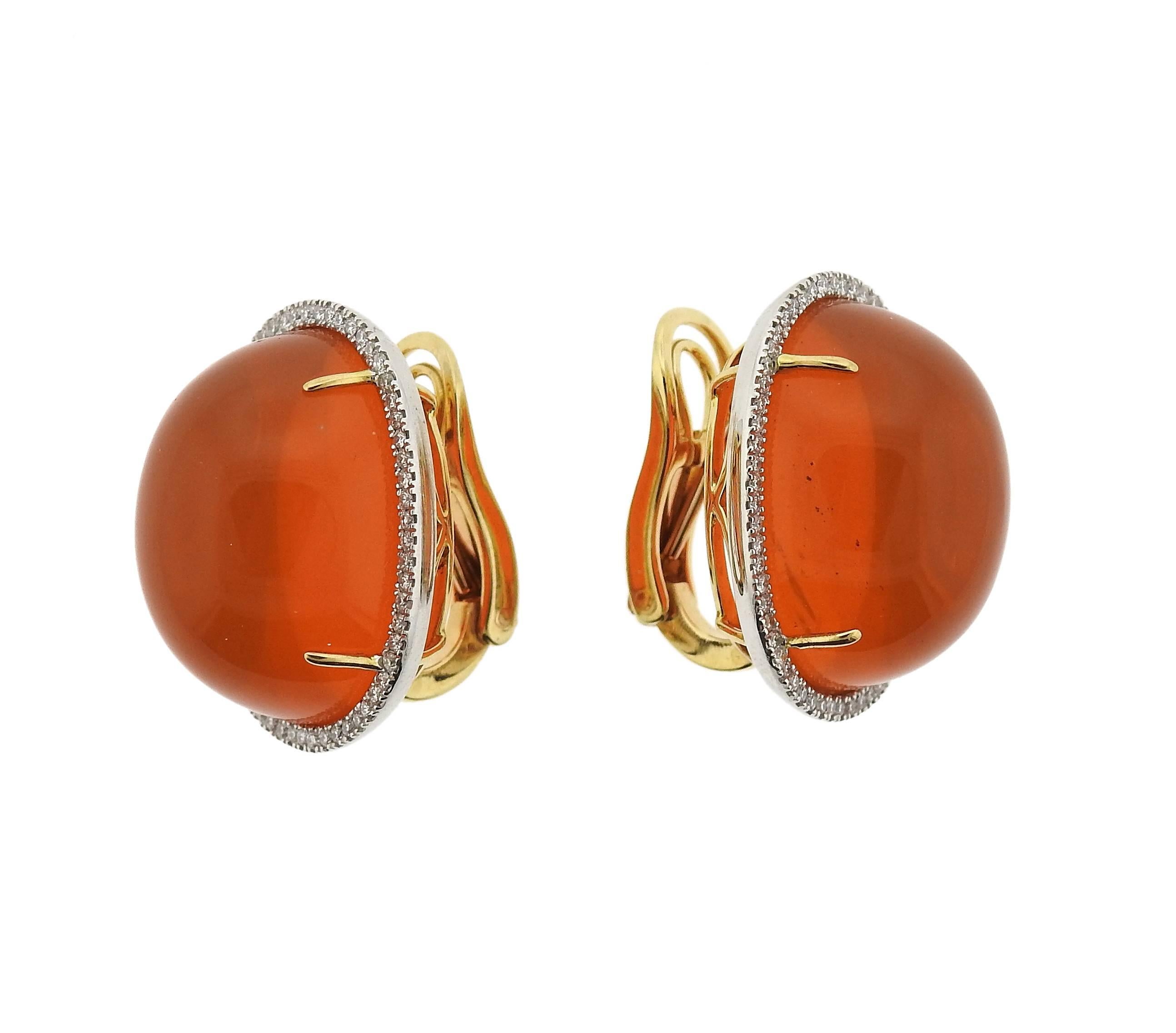 18k gold earrings, crafted with 20mm x 15mm Mexican fire opal cabochons, surrounded with approximately 0.30ctw in diamonds. Earrings measure 22mm x 18mm. Weight - 21.4 grams 