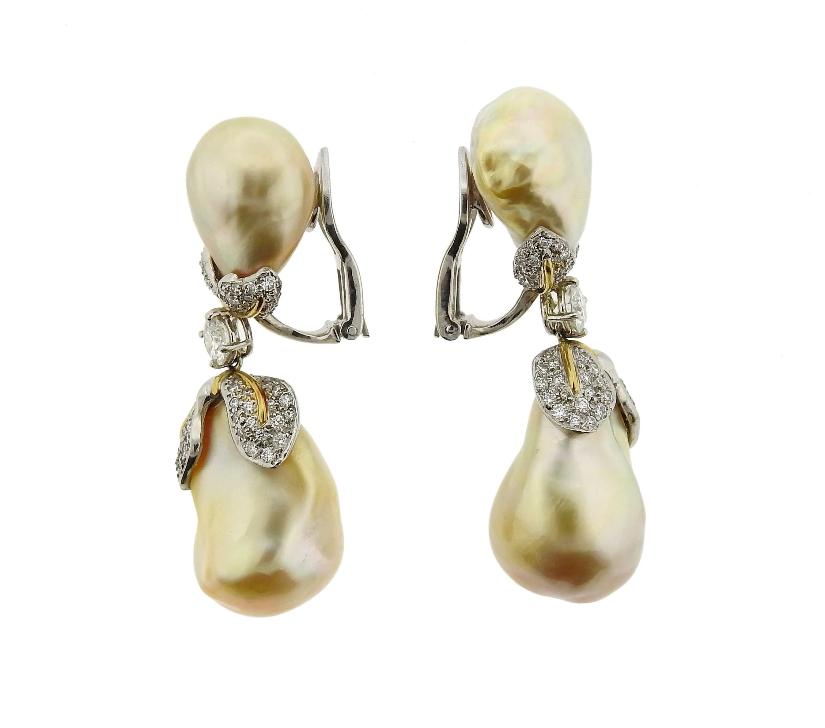 A pair of pearl and diamond earrings, crafted by Donna Vock in platinum with 18k gold accents. Earrings feature white and golden Baroque pearls, surrounded with approximately 2.00ctw in G/VS diamonds. Earrings measure 50mm x 17mm. Marked: Vock,
