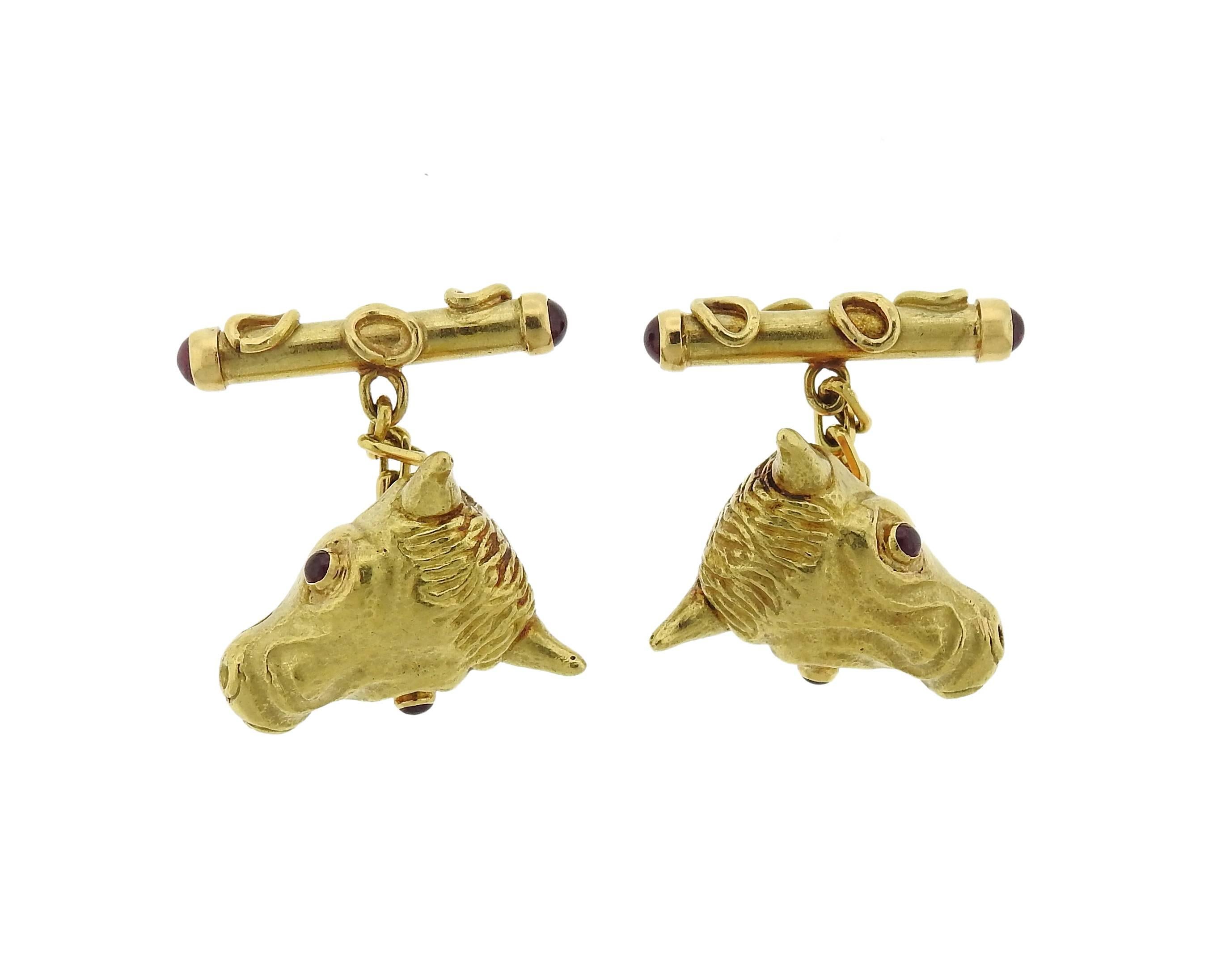 Pair of large 18k yellow gold cufflinks,  by Andrew Grima, featuring bull's head, with ruby eyes. Cufflink top measures 23mm x 20mm. Marked: 750, Grima. Weight - 22.8 grams 