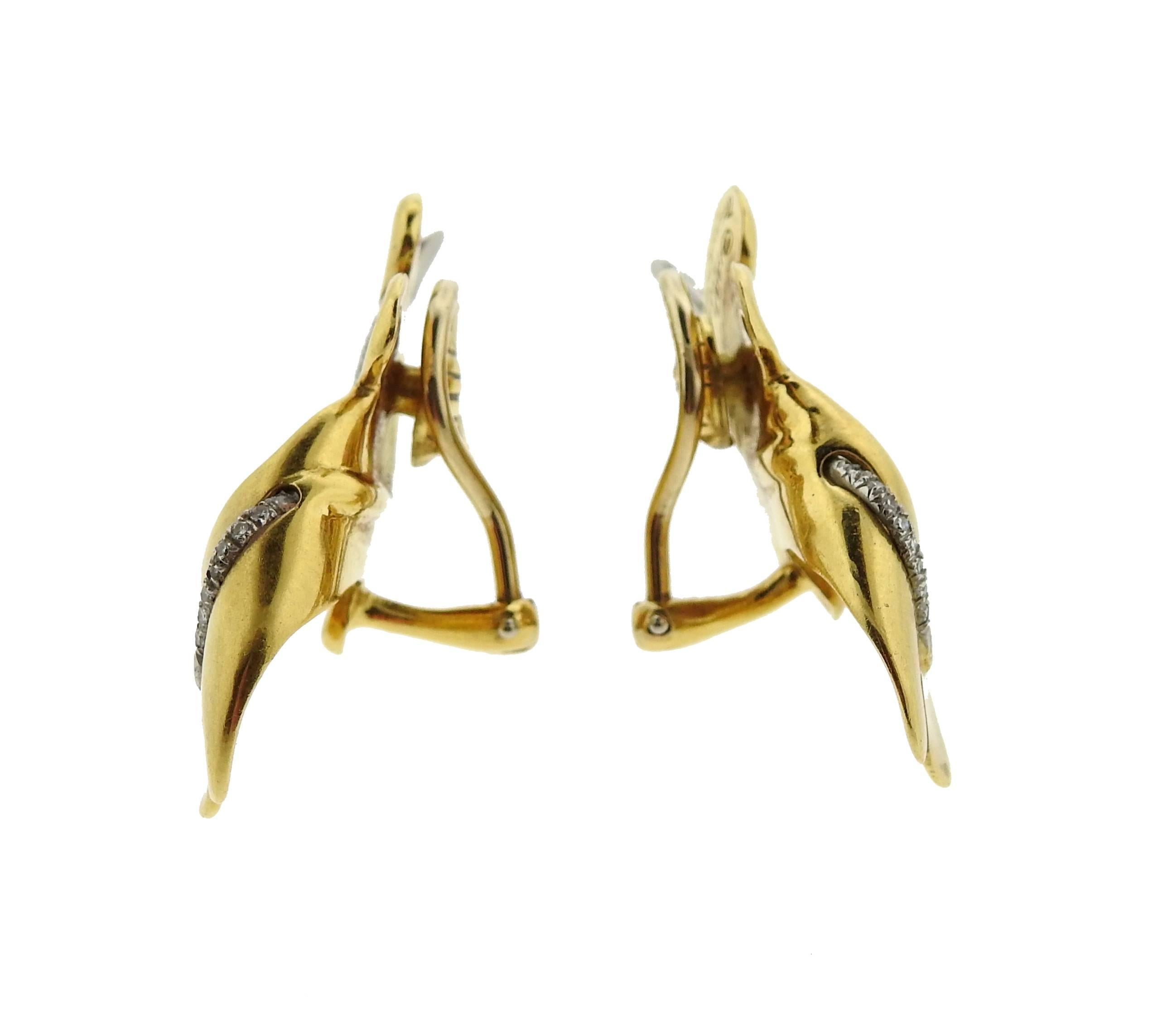 18k gold and platinum leaf earrings, crafted by Tiffany & Co in circa 1987. Earrings measure 40mm x 21mm, with diamond accents. Marked: 1987, 18k plat, Tiffany & Co . Weight: 20.4 grams 