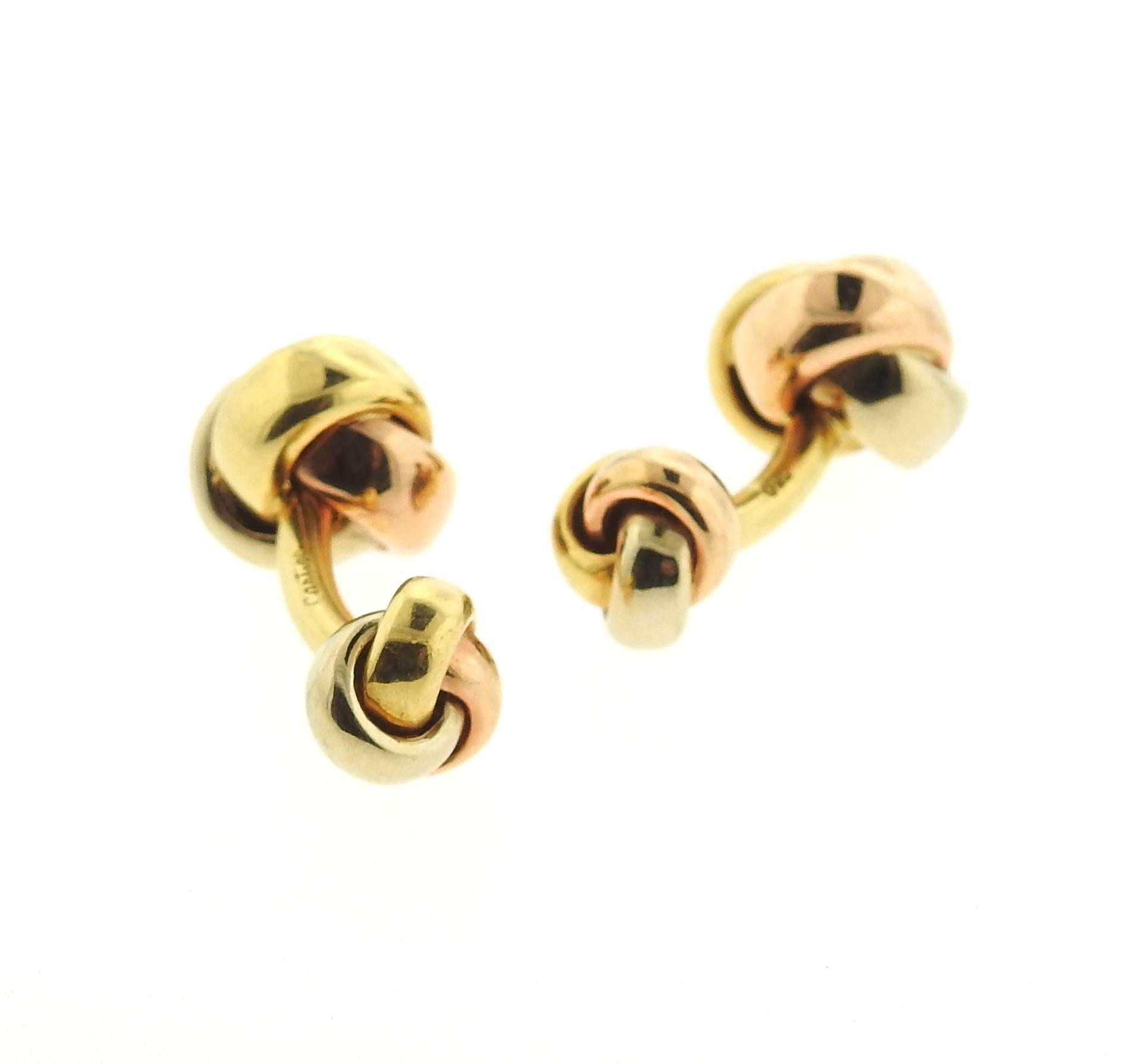 Pair of 18k tri color gold knot cufflinks, crafted by Cartier for Trinity collection. Cufflink top measures 14mm x 14mm, back - 10mm x 10mm. Marked: Cartier, 750. Weight - 22.1 grams