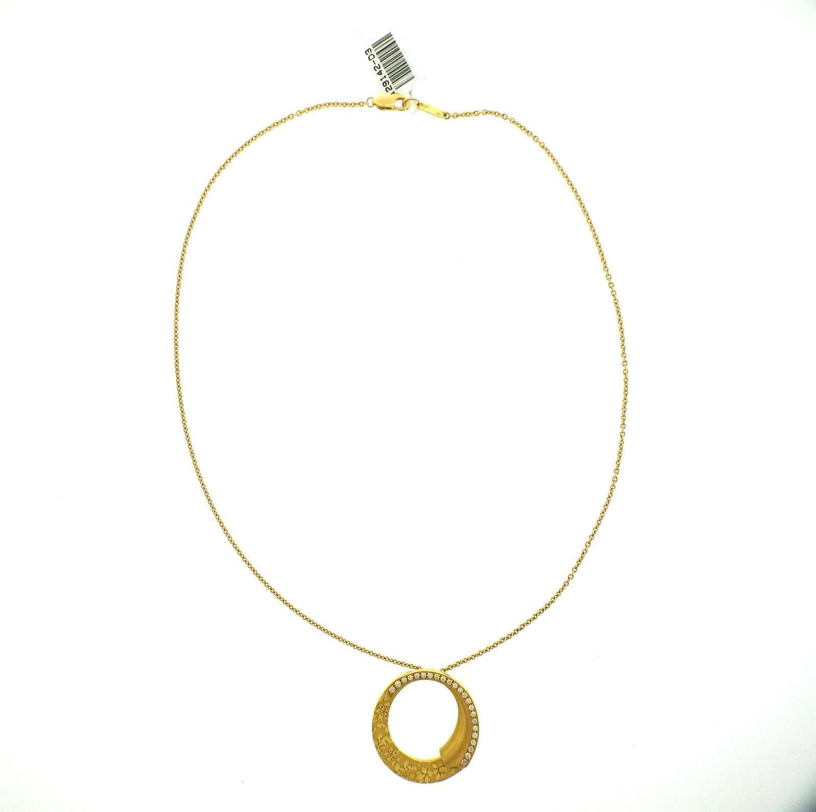 18k yellow gold necklace featuring a diamond circle pendant. Crafted by Carrera Y Carrera for the Cervantes collection. Necklace measures 17.5" long, pendant measures 30mm in diameter. Set with approximately 0.28ctw of G/VS diamonds. Weight is