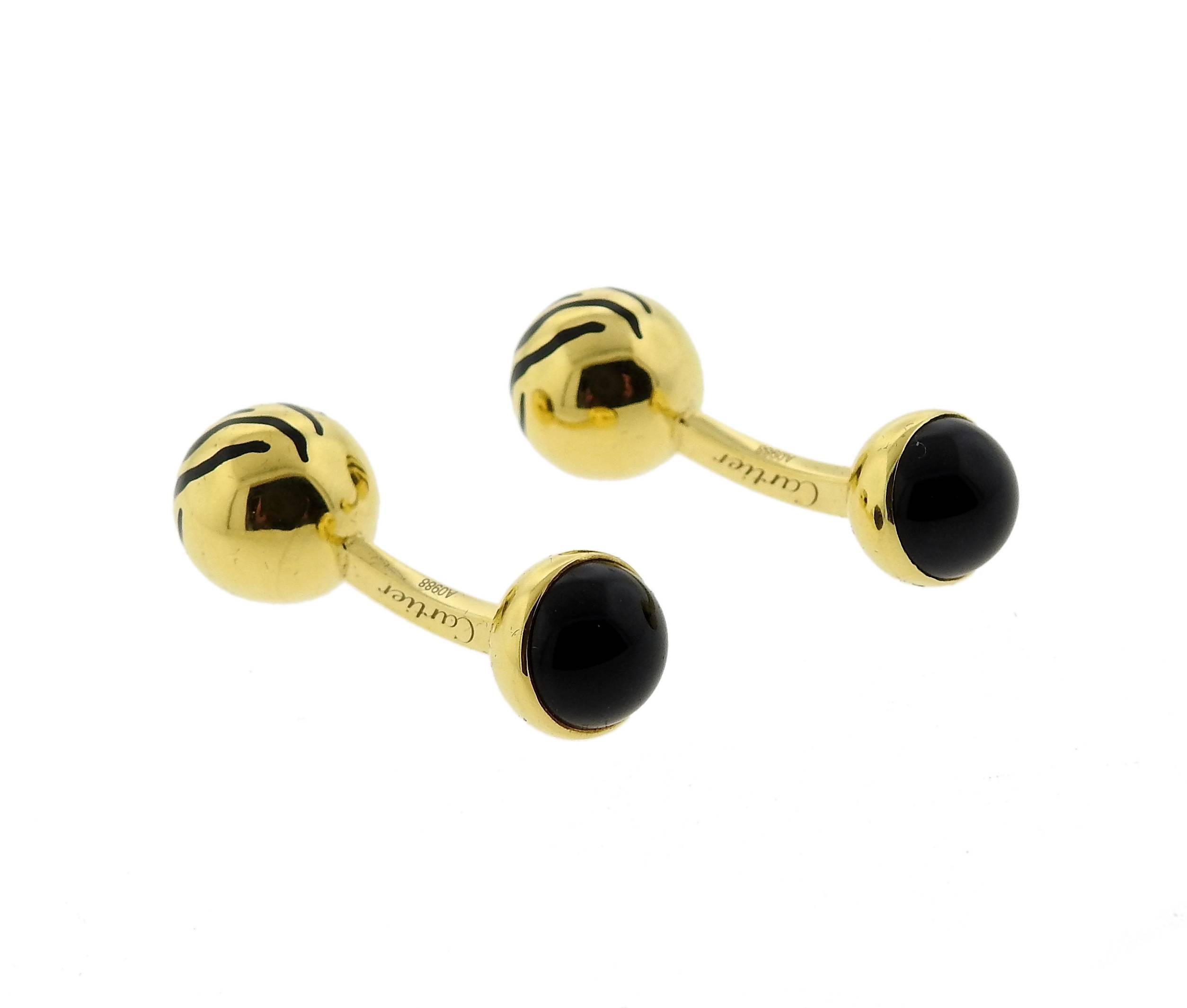 Pair of 18k yellow gold ball cufflinks, crafted by Cartier, set with black onyx. Cufflink top is 10mm in diameter, back - 9mm. Marked: Cartier, Au750, made in Italy, 4697AR. Weight - 14.8 grams 
Come with box and papers 