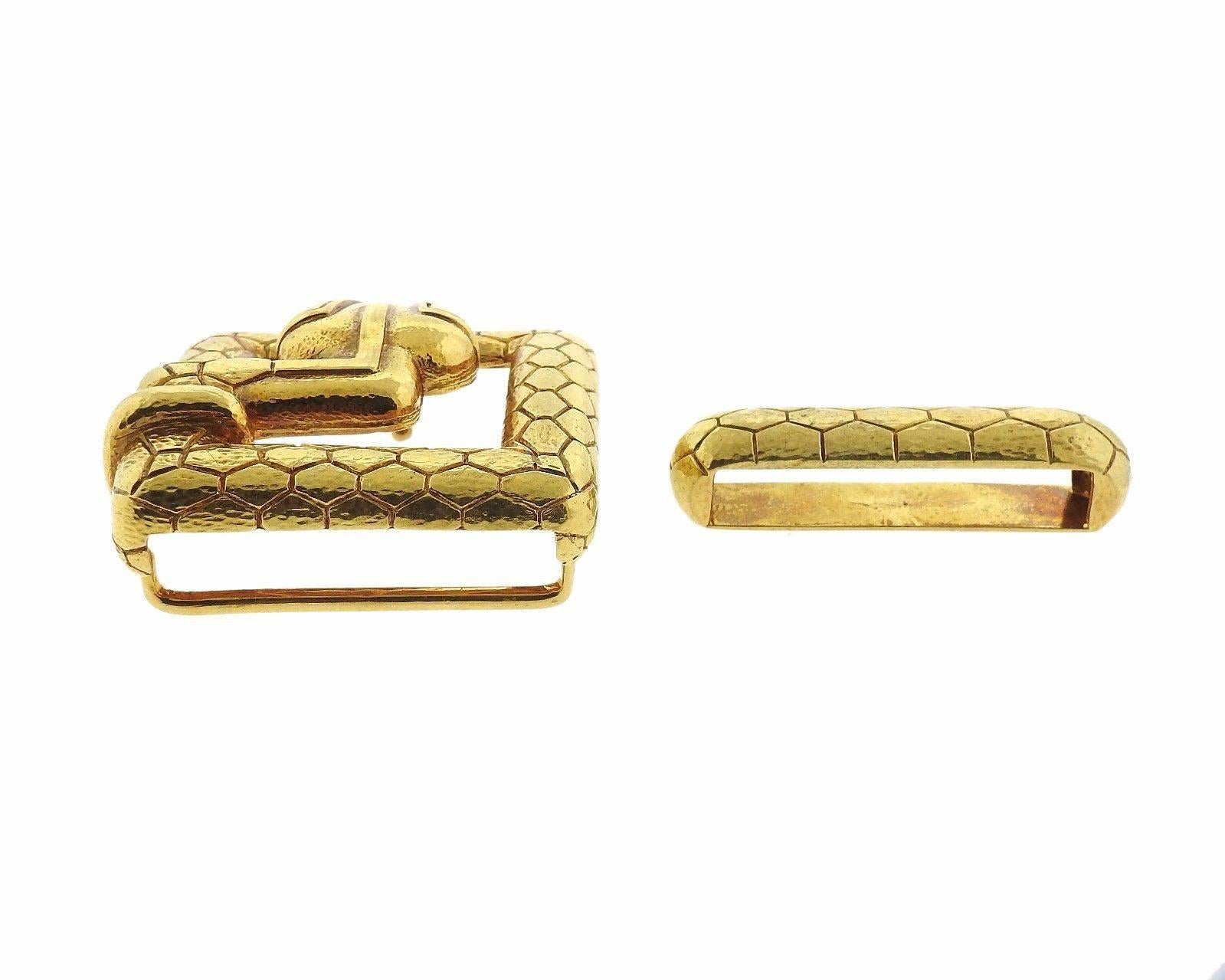 An 18k yellow gold belt buckle depicting a snake.  The buckle measures 47mm x 48mm and the belt loop is 47mm x 11mm.  The weight of the set is 62.8 grams.  Marked: Webb, 18k.