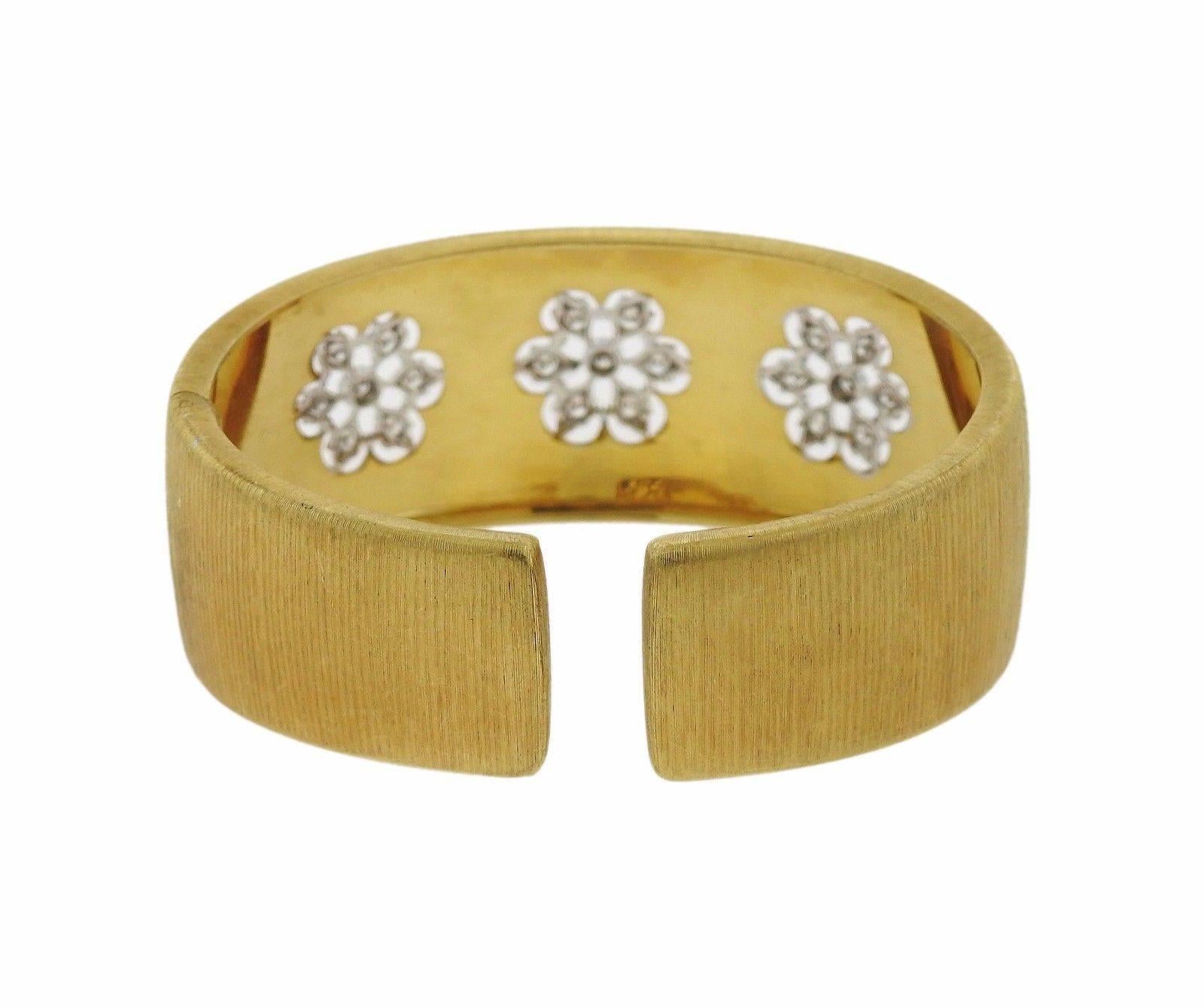 An 18k yellow gold cuff bracelet set with approximately 0.84ctw of H/VS diamonds.  The bracelet will fit a 7