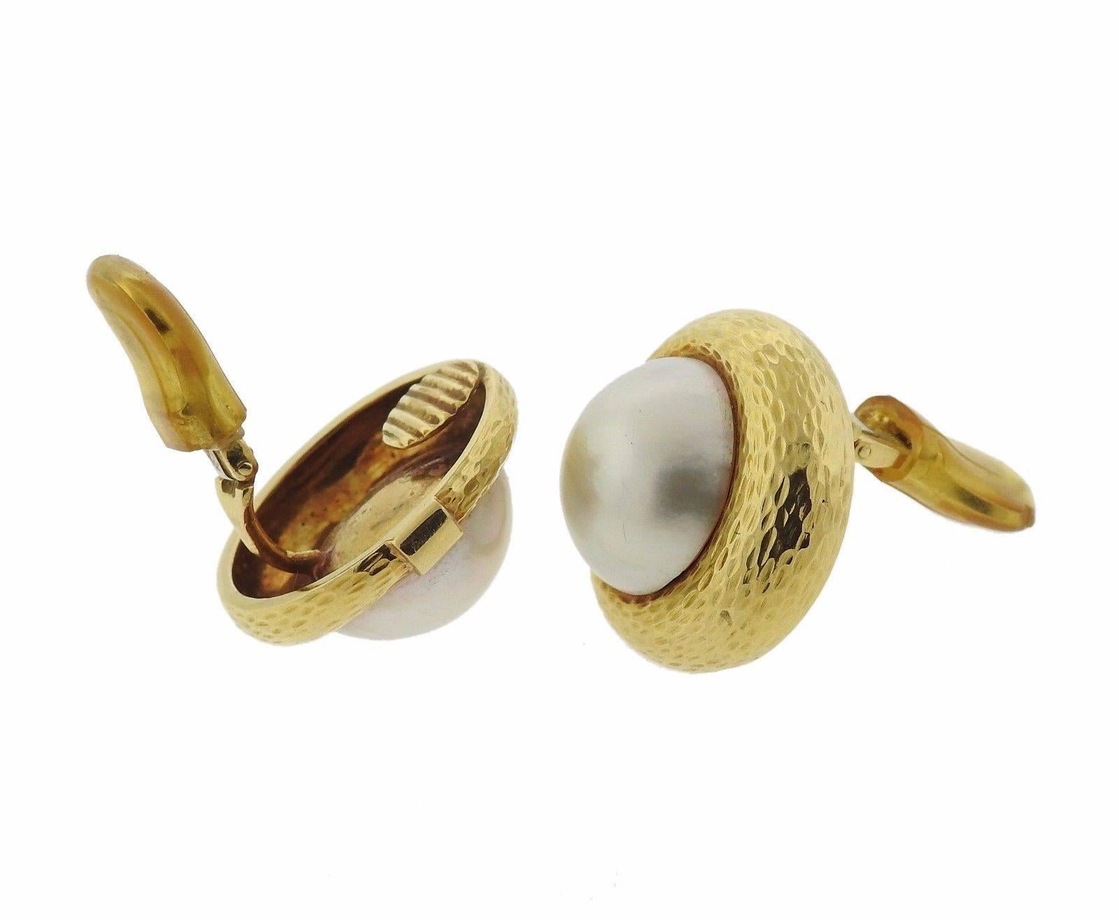 A pair of 18k yellow gold earrings set with 18.2mm Mabe pearls.  The earrings measure 26mm in diameter and weigh 29.3 grams.  Marked: 18k, A.Clunn.