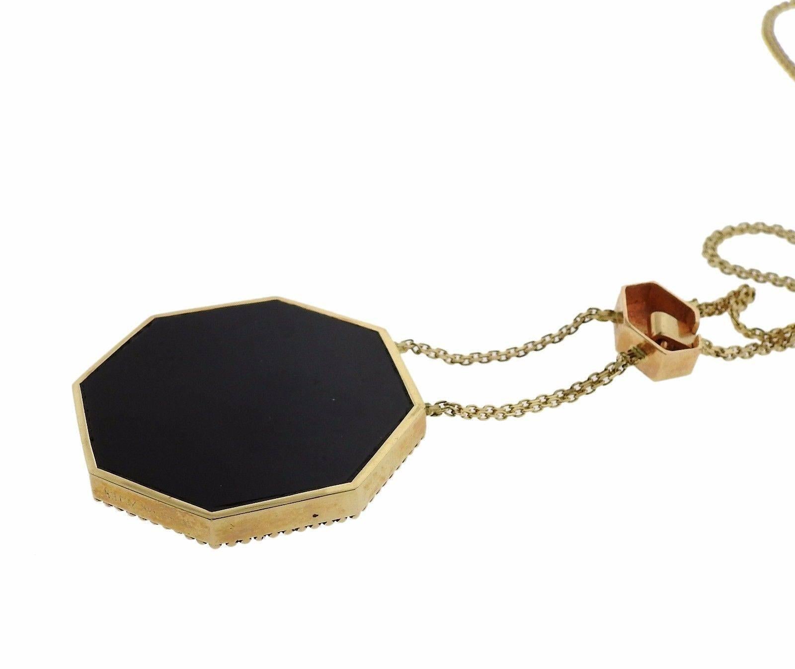 A 14k gold and sterling silver necklace set with onyx, mother of pearl, ruby and approximately approximately 0.05ctw of H/VS-SI diamonds.  The necklace is 16 3/4" long, pendant drop is 3" long, pendant measures 40mm x 40mm.  The necklace