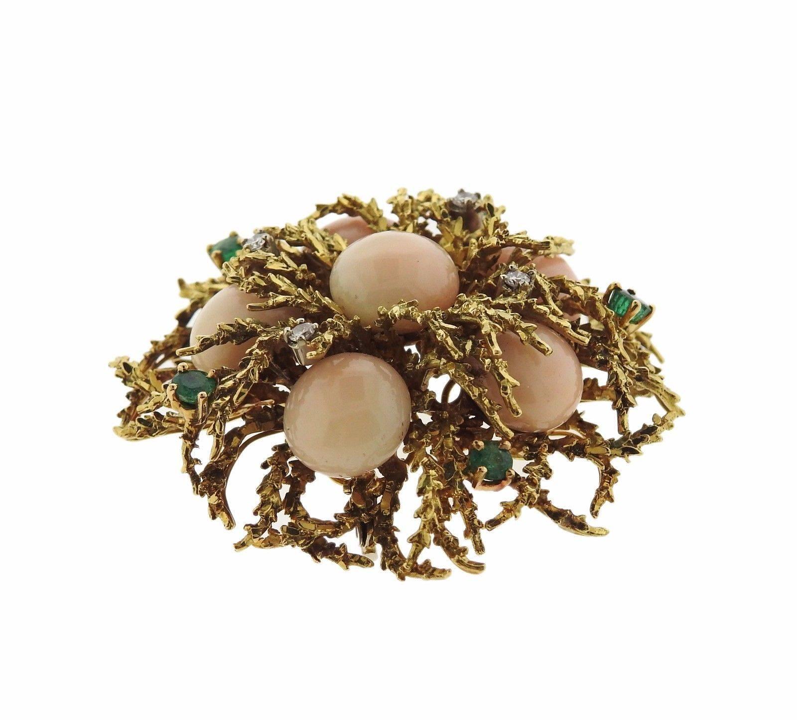 An 18k yellow gold brooch set with coral, emeralds and approximately 0.12ctw of H/VS-SI diamonds.  The brooch measure 45mm x 43mm and weighs 34.9 grams.  Marked: 18k, Italy.