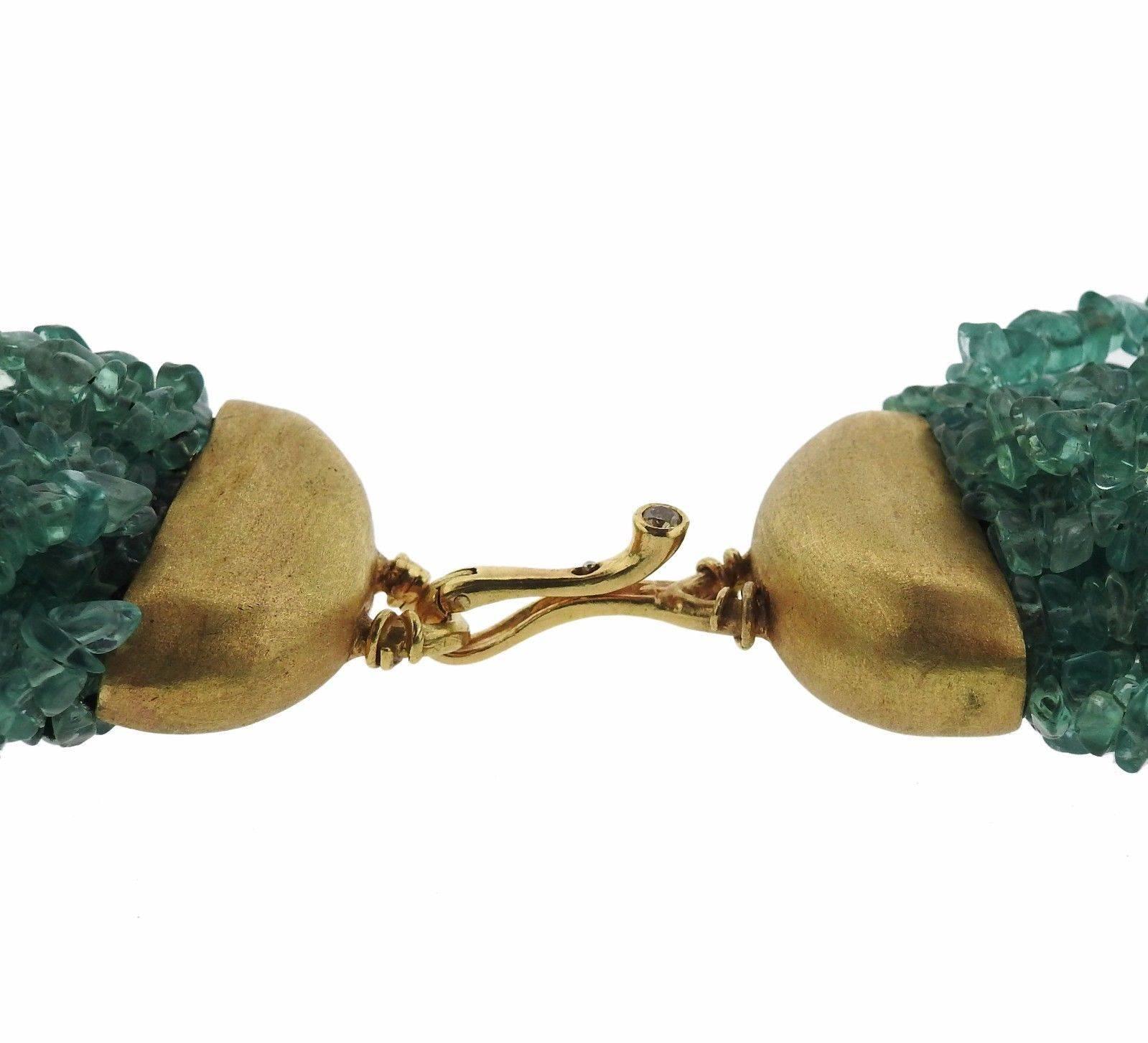 An 18K yellow gold multi stransd necklace set with seafoam green gemstone beads and  a fancy color diamond weighing approximately 0.12ct.  The necklace is 25" long and approx. 2" wide.  Marked: 750, Angela Pintaldi.  The weight of the