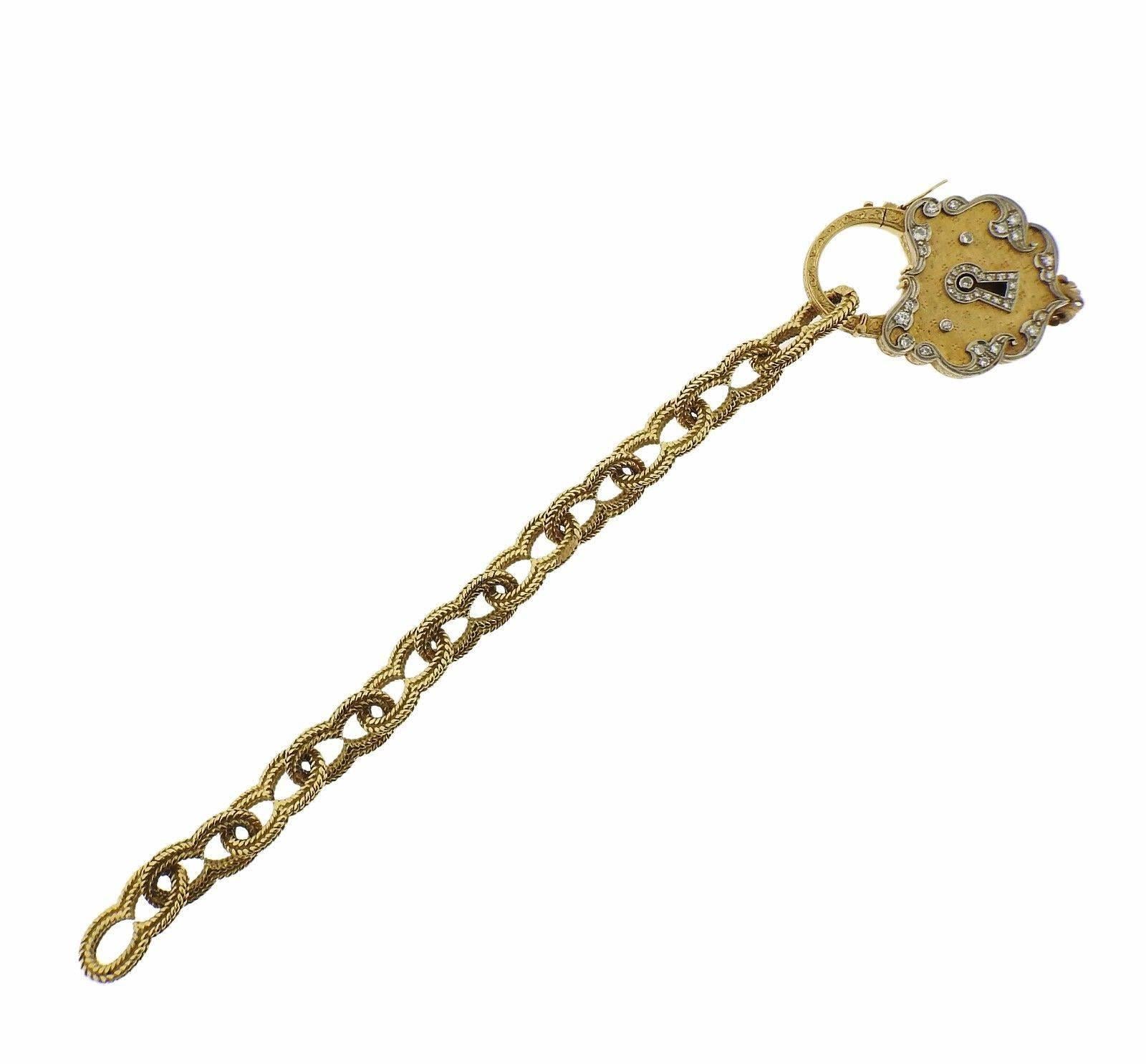 An 18k yellow gold bracelet set with approximately 0.35ctw of H/SI diamonds and turquoise.  The padlock measures 48mm x 35mm, bracelet is  7 1/4" long and 12mm wide.  The weight of the piece is 73 grams.  Marked: 750, gold assay mark.