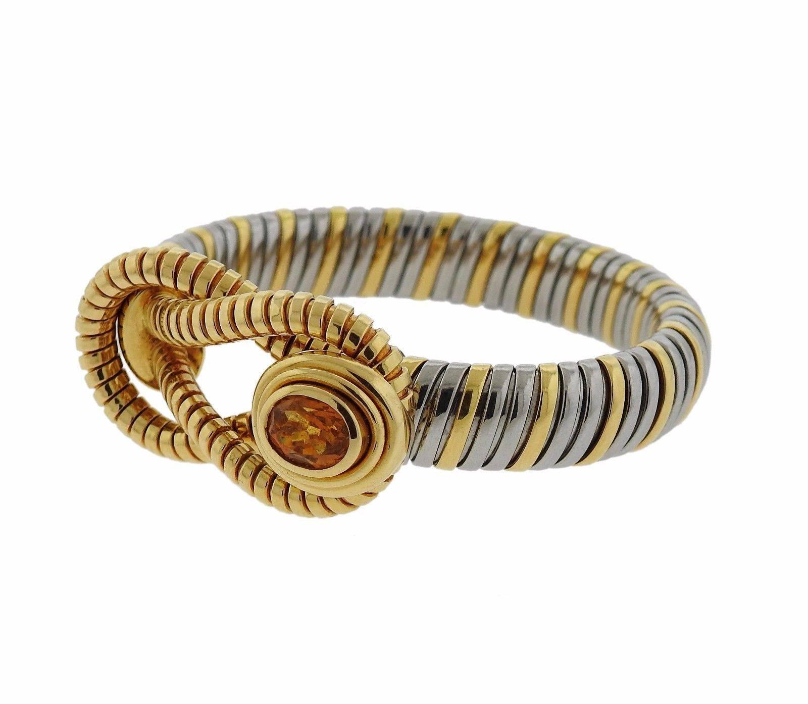 An 18k yellow gold and stainless steel bracelet set with a Citrine.  The bracelet is 8" long and weighs 37.1 grams.  Marked: Cartier, 103687.