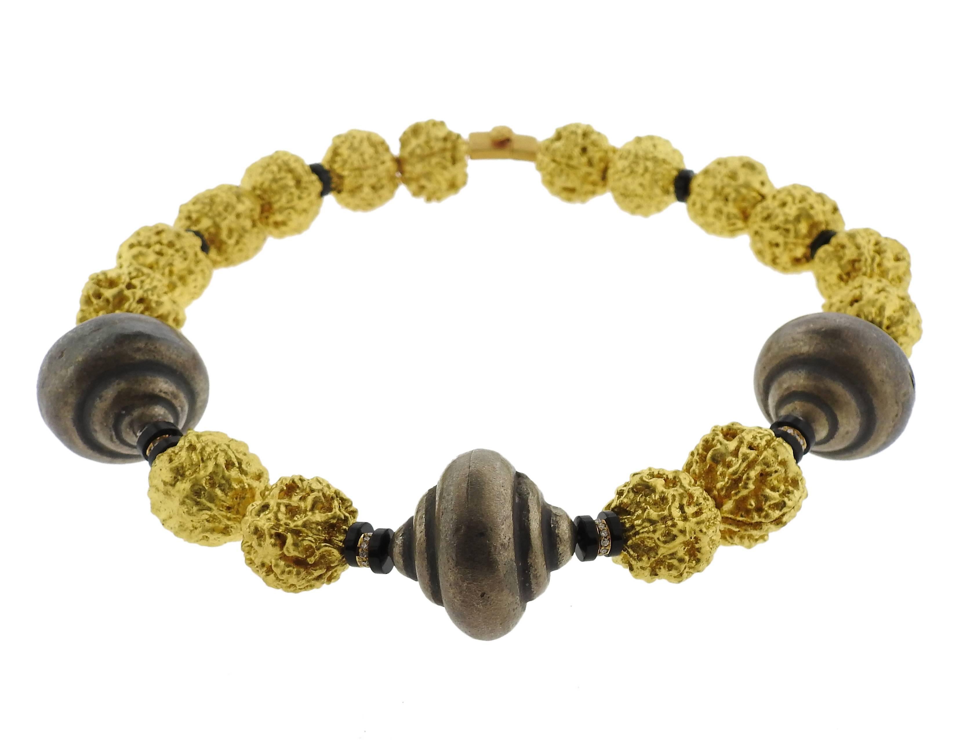 An 18k yellow gold necklace adorned with onyx and approximately 0.30ctw of H/VS diamonds.  The necklace is 17