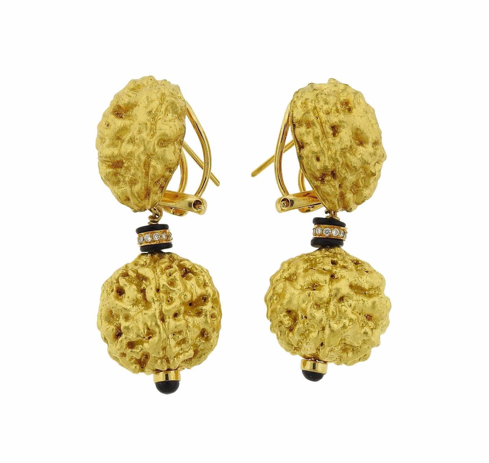 A pair of 18k yellow gold earrings set with onyx and approximately 0.10ctw of H/VS diamonds.  The earrings are 46mm x 20mm , with collapsible posts.  The pair weighs 19 grams.  Marked with the maker's mark, 18k, 01, 509.