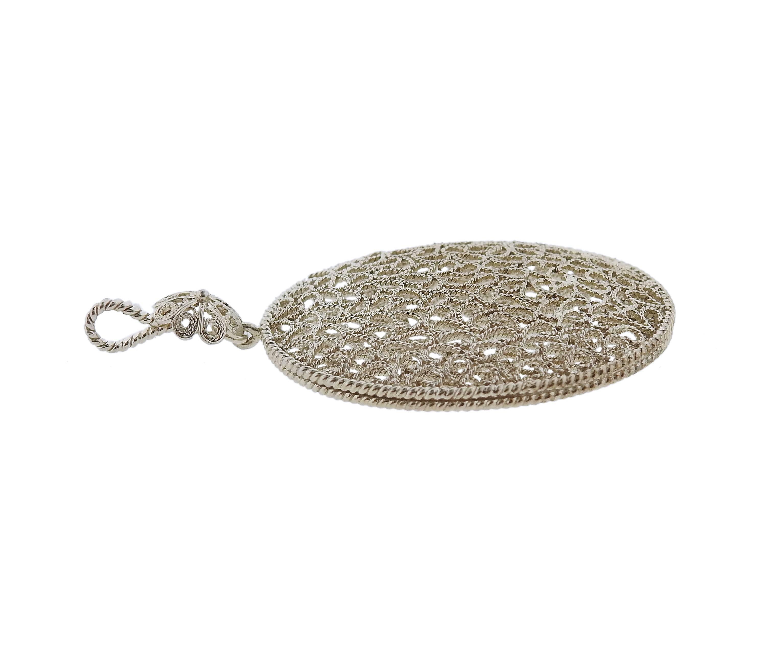 A Buccellati Sterling Silver Openwork floral oval pendant. Pendant measures 50mm including bale X 29mm. Weight is 5.4 grams, marked Buccellati 925 italy.  