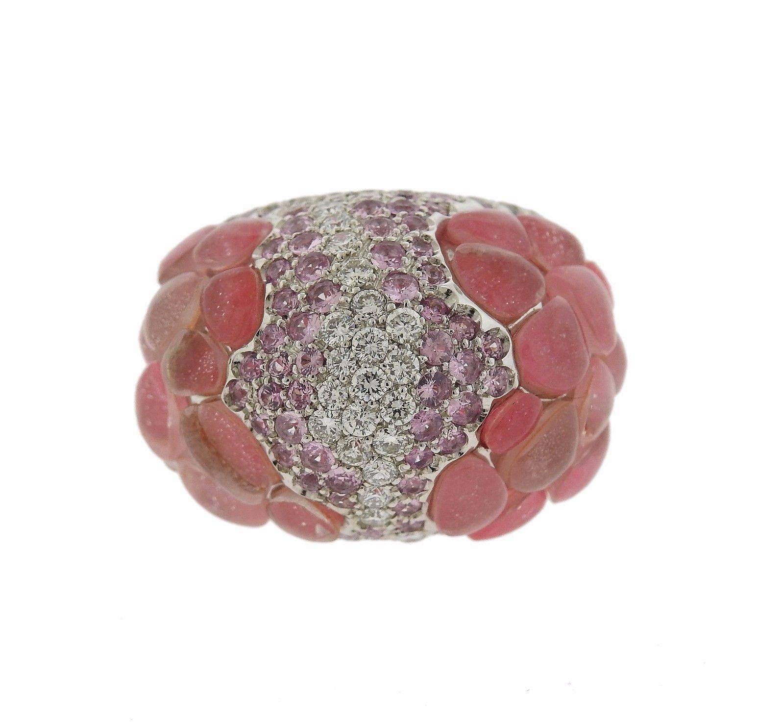 An 18k white gold ring set with pink sapphires and approximately 0.90ctw of G/VS diamonds.  The ring is a size 6 1/2, ring top is 20mm x 28mm.  The weight of the ring is 21.2 grams.  Marked: Porrati, 750, Italian marks. 