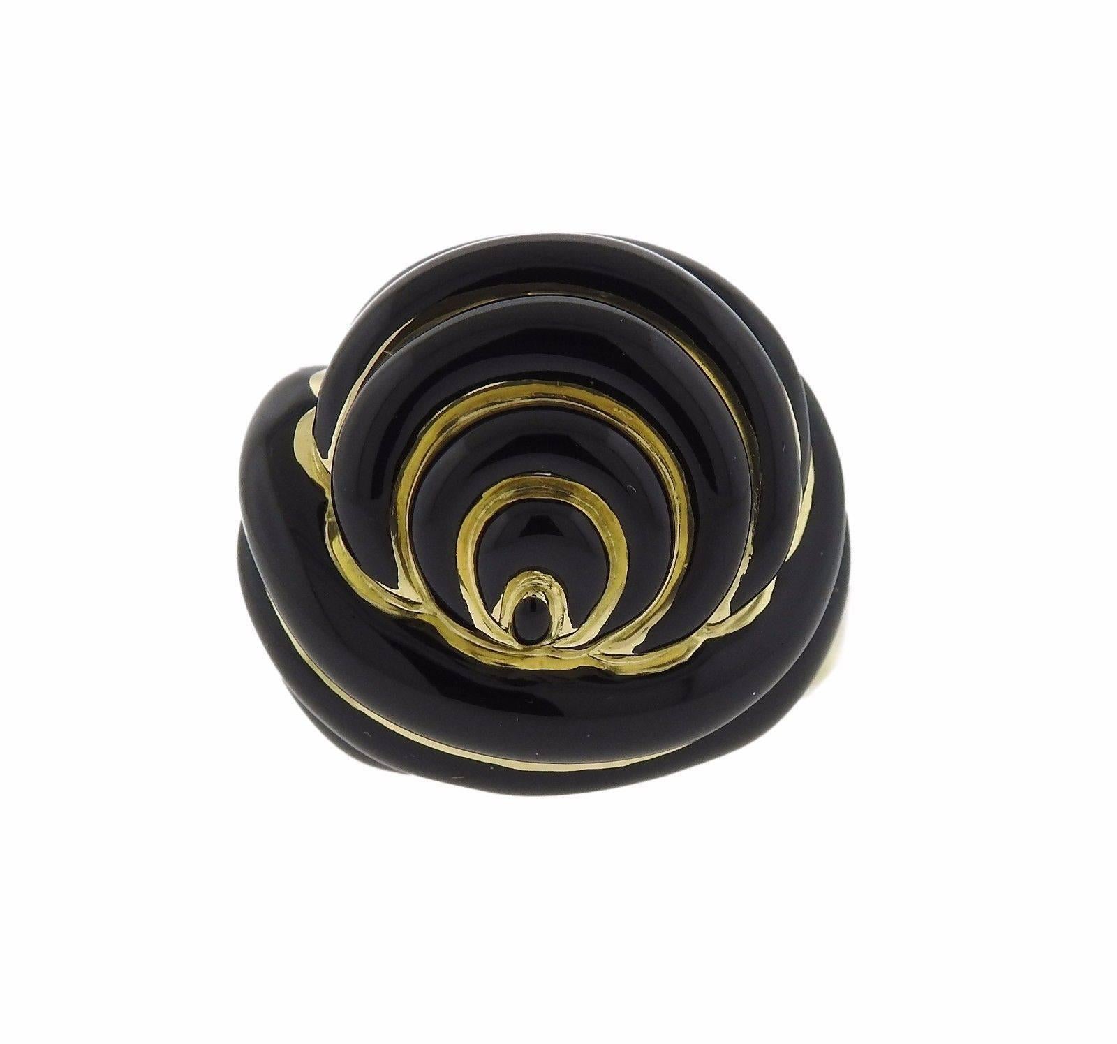 An 18k yellow gold ring set with black enamel.  The ring is a size 8.  The ring top is 24mm x 26mm and sits 16mm from the top of the finger.  The weight of the piece is 27.4 grams.  Marked: 18k A.Clunn.