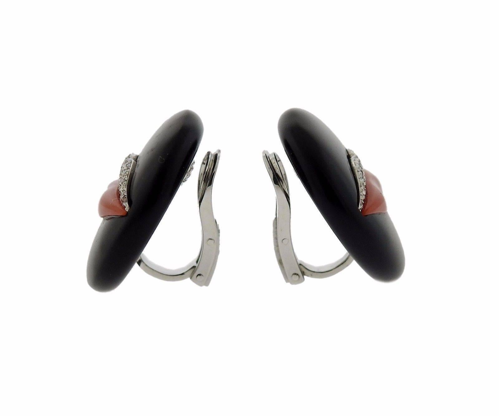 A pair of 18k white gold earrings set with coral, jet, and approximately 0.48ctw of G/VS diamonds.  The earrings are 25mm in diameter and weigh 16.5 grams.  Marked: Enigma,750 , made in Italy, 861AL.  The current retail is $6700.